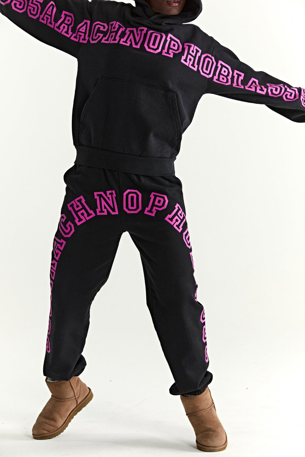 Black 13oz cotton fleece hoodie and sweatpants with pink "ARACHNOPHOBIA" puff print.
