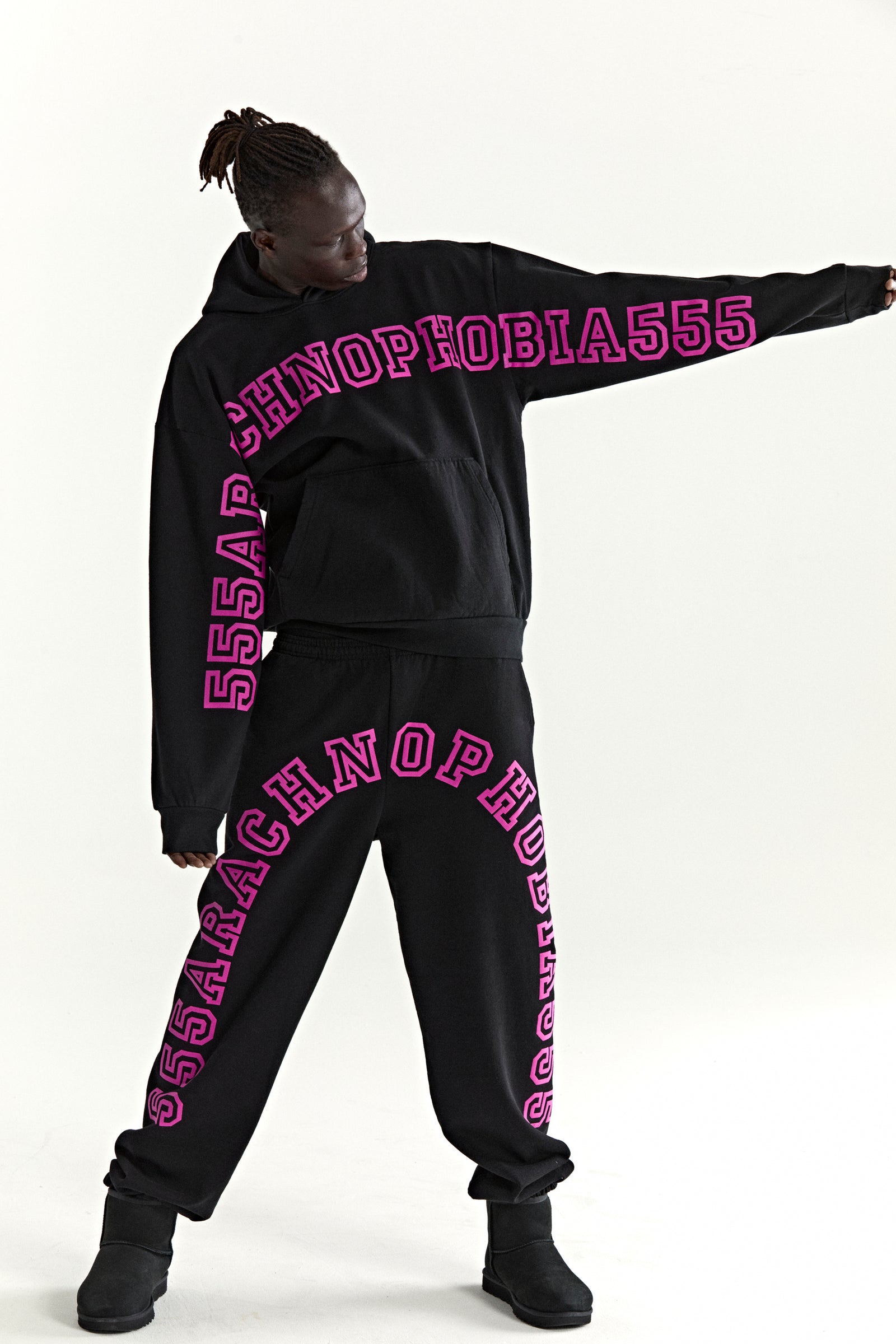 Black ARACH hoodie and sweatpants set with pink "ARACHNOPHOBIA555" puff print.