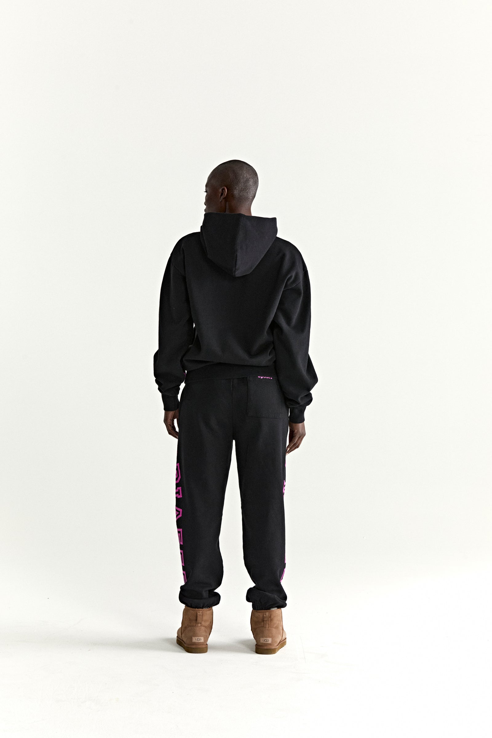 Black ARACH HOODIE and sweatpants with pink text print, 100% cotton fleece.