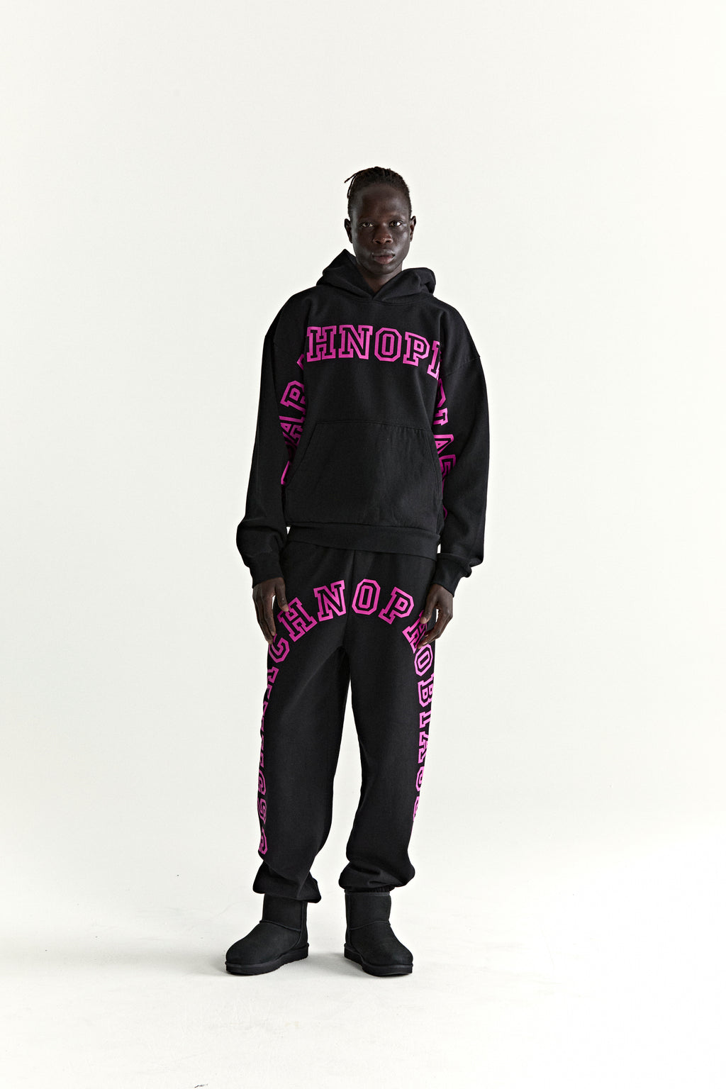 Black cotton fleece ARACH HOODIE and sweatpants with pink puff print text, kangaroo pocket.