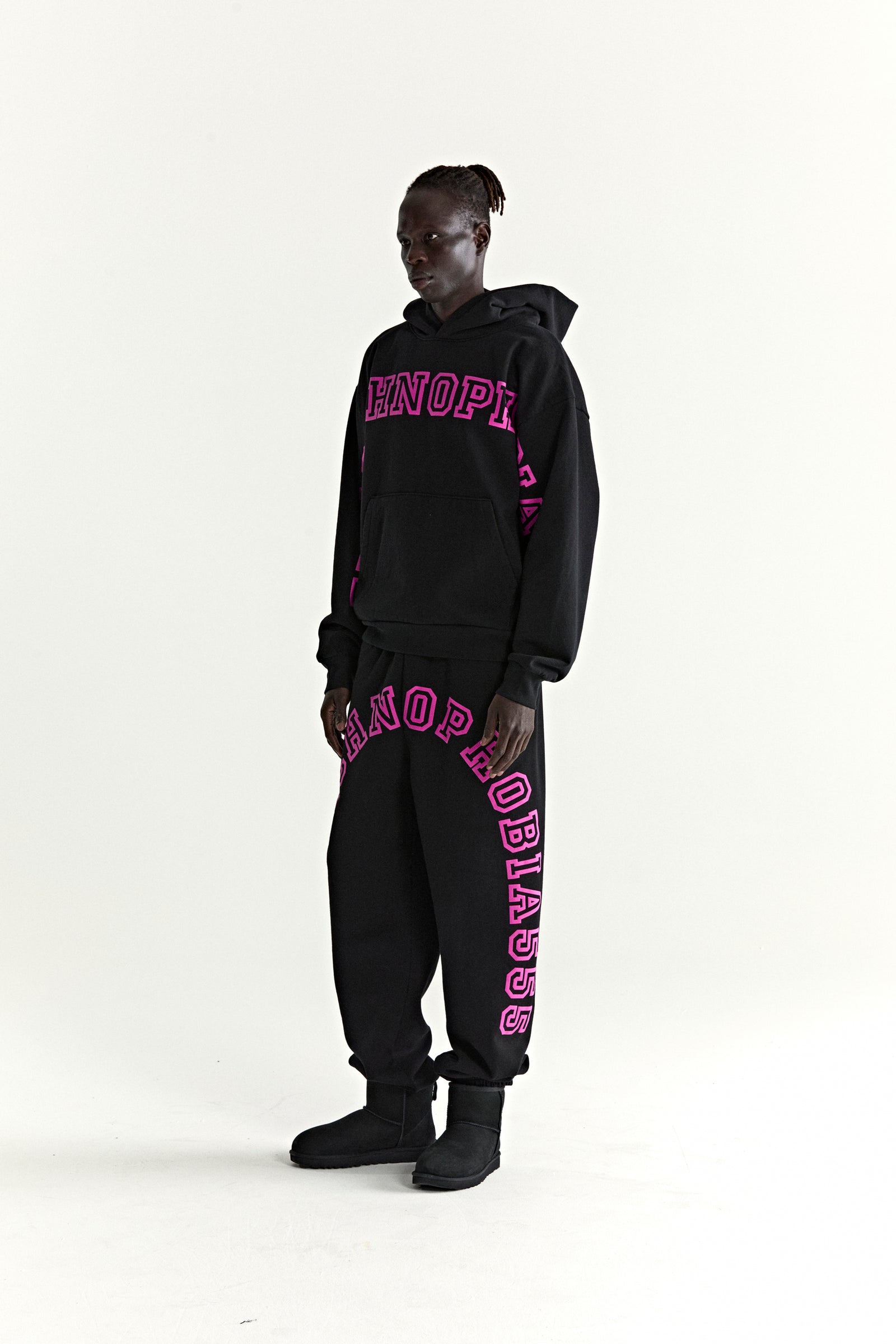 Black cotton fleece hoodie and sweatpants with pink puff print text.