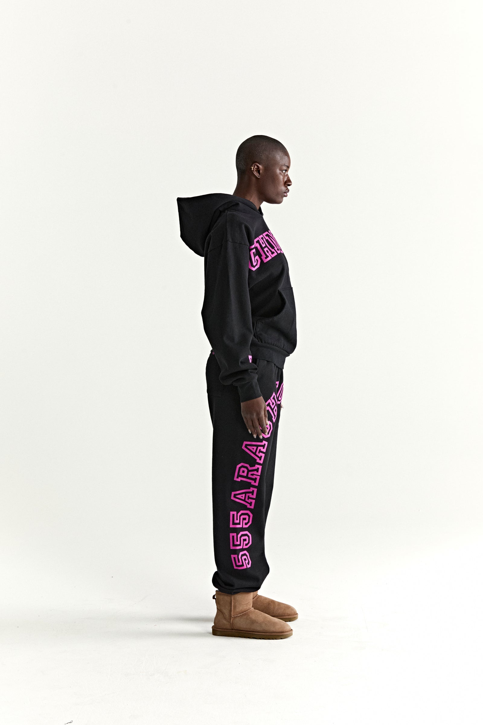 Black 13oz cotton fleece ARACH hoodie and sweatpants with pink puff print text, kangaroo pocket, rib knit cuffs.