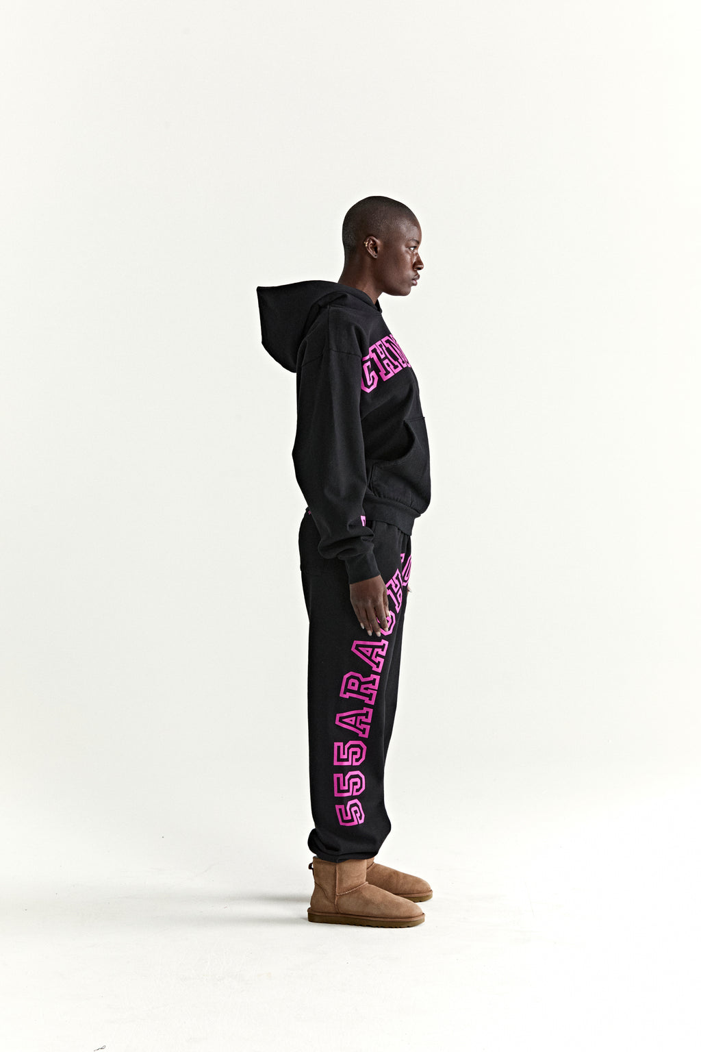 Black 13oz cotton fleece ARACH hoodie and sweatpants with pink puff print text, kangaroo pocket, rib knit cuffs.