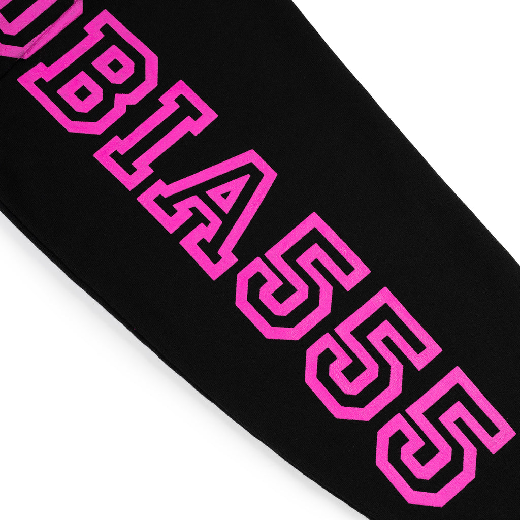 Black cotton fleece hoodie sleeve with bold pink puff print text.