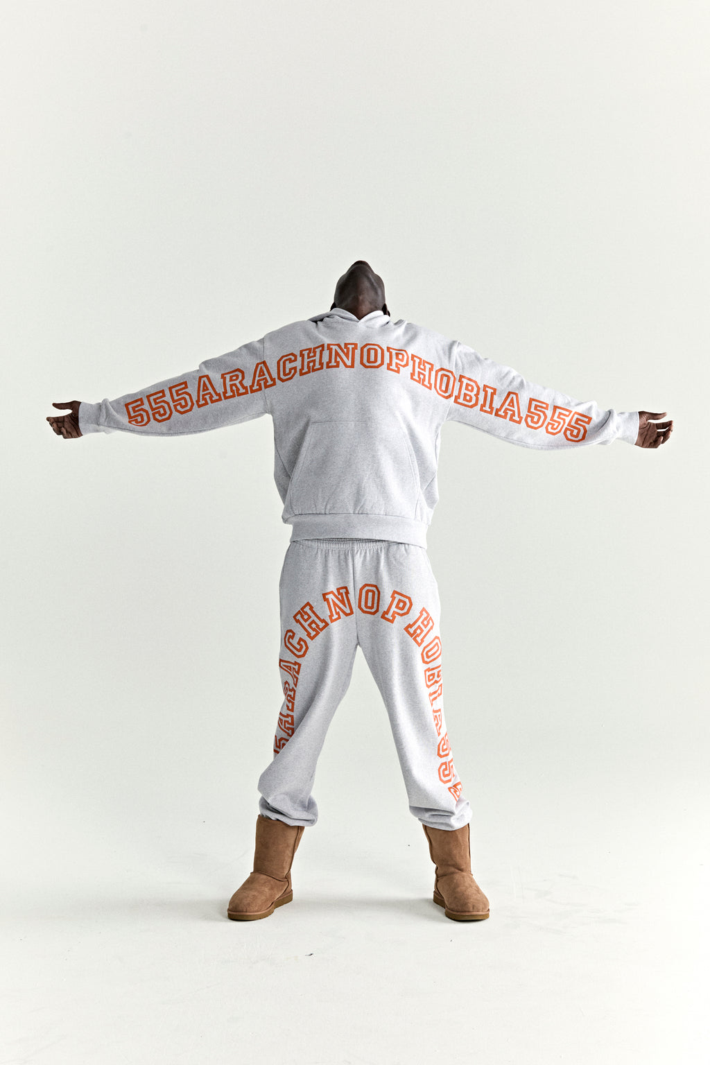 Light gray 100% cotton fleece hoodie and sweatpants with orange "ARACHNOPHOBIA" puff print.