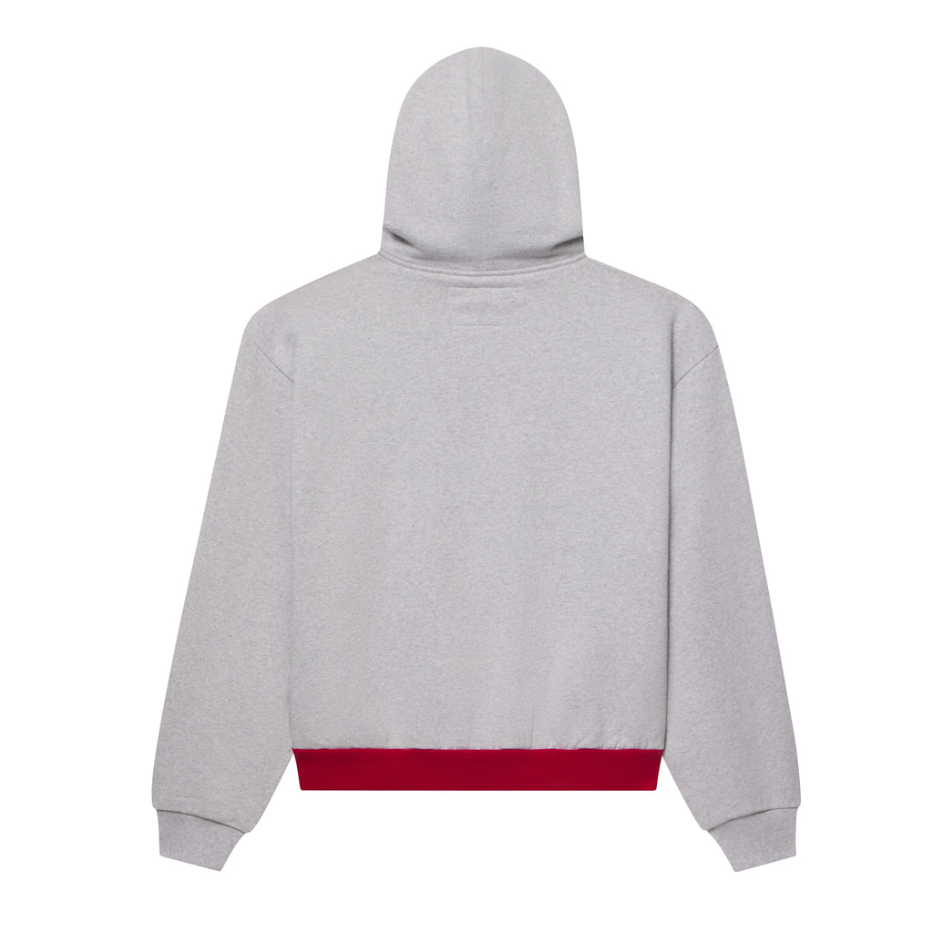 Back view of a grey 13oz cotton fleece zip hoodie with a contrasting red color block hem.