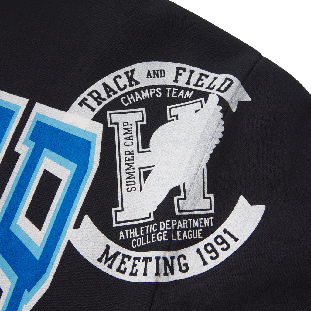 Black 13oz cotton fleece zip hoodie featuring a varsity-inspired Track and Field graphic print in blue and white.