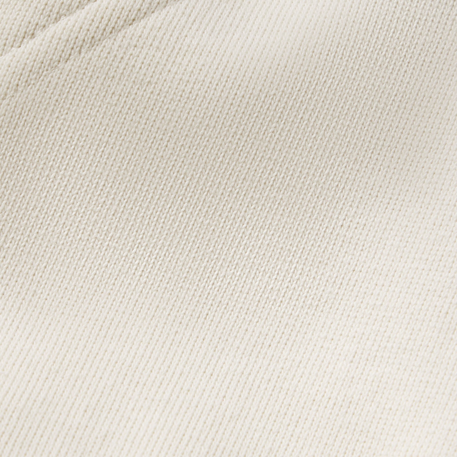 Close-up of off-white 13oz cotton fleece fabric texture from the Campers Field zip hoodie.