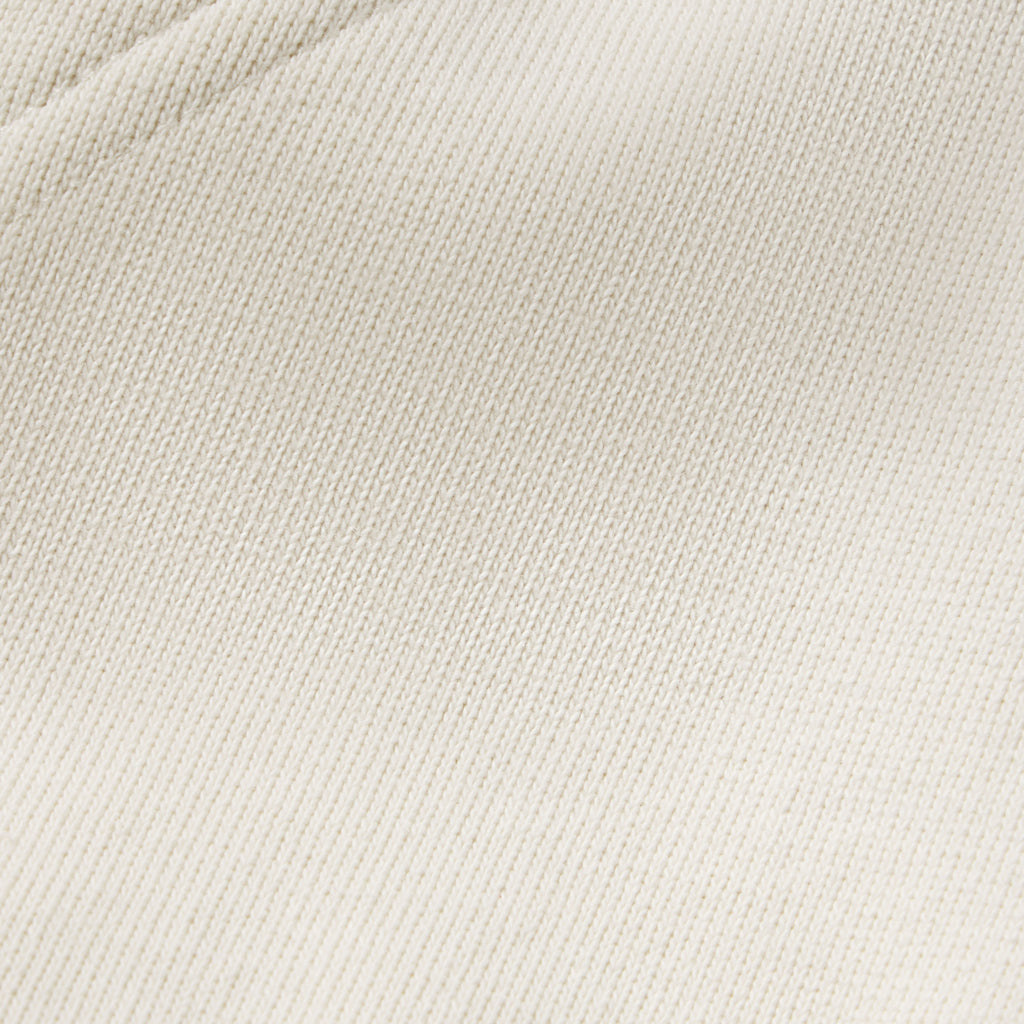 Close-up of off-white 13oz cotton fleece fabric texture from the Campers Field zip hoodie.