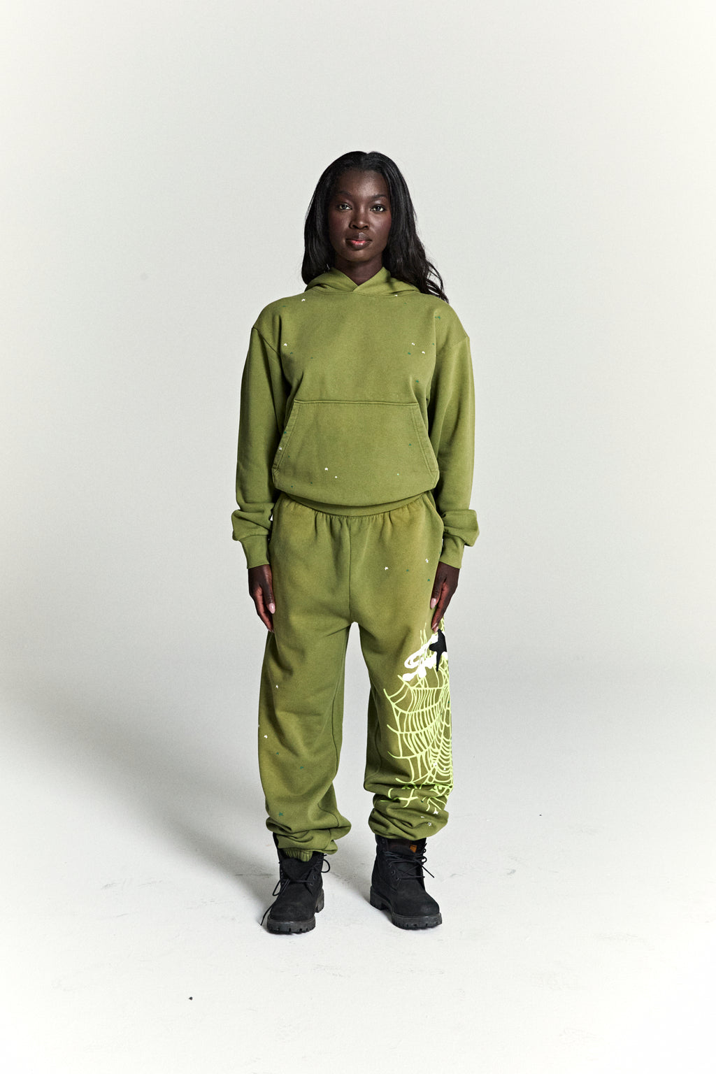 Olive green cotton fleece hoodie and sweatpants set with scattered star print and a large web print.