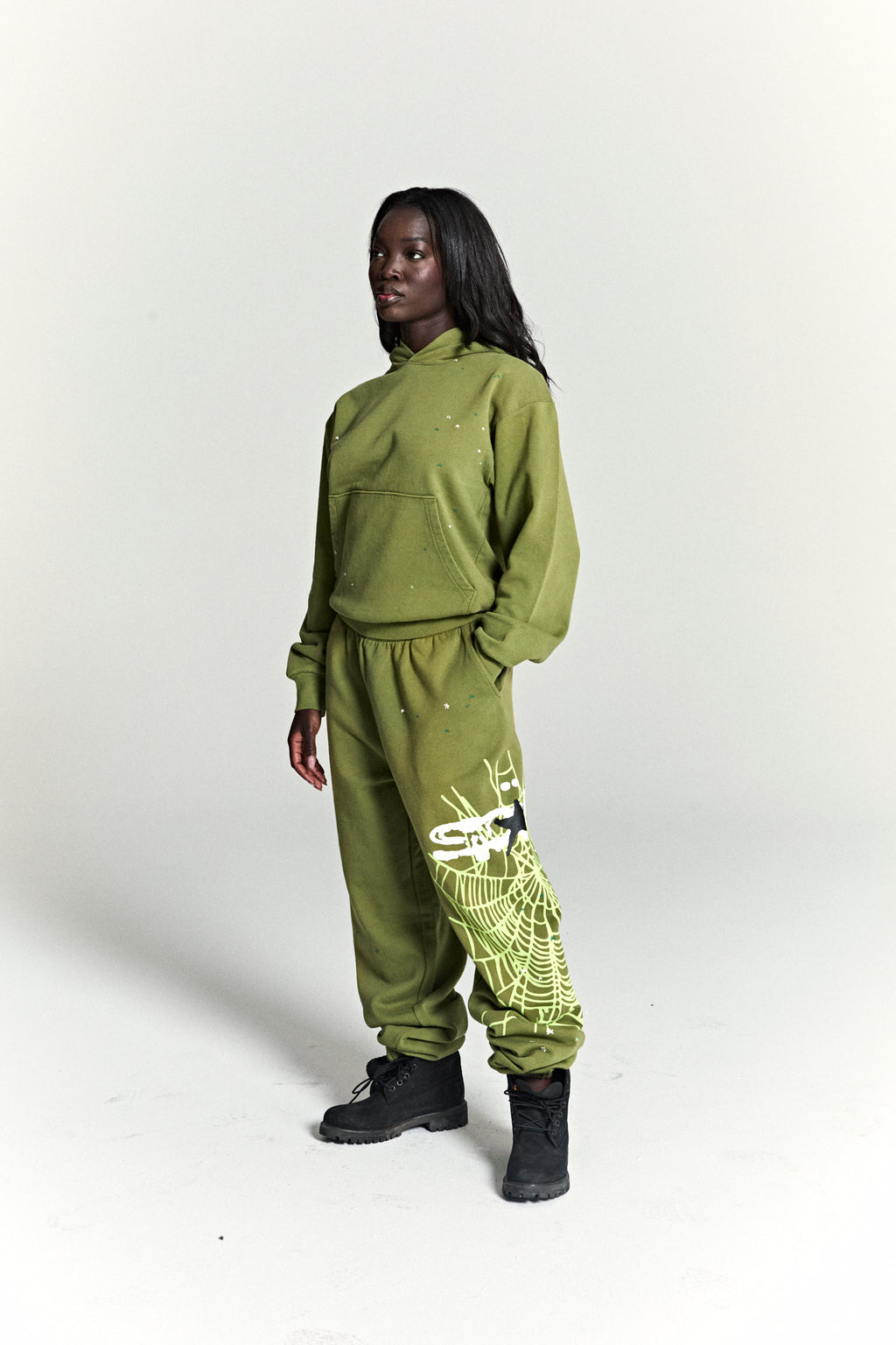 Olive green heavy web hoodie and sweatpants set with scattered stars and a large web print.