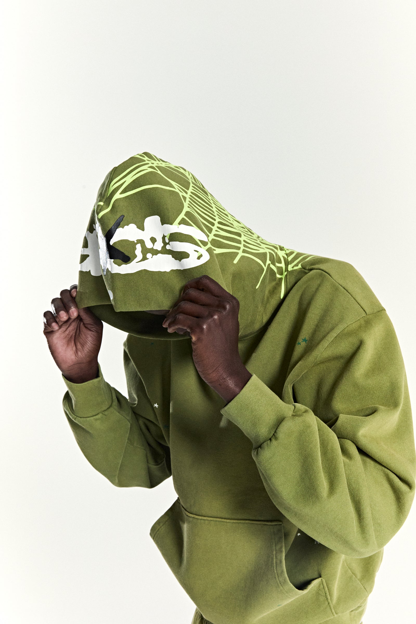 Olive green heavy web hoodie with puff print stars and a neon green spider web hood design.