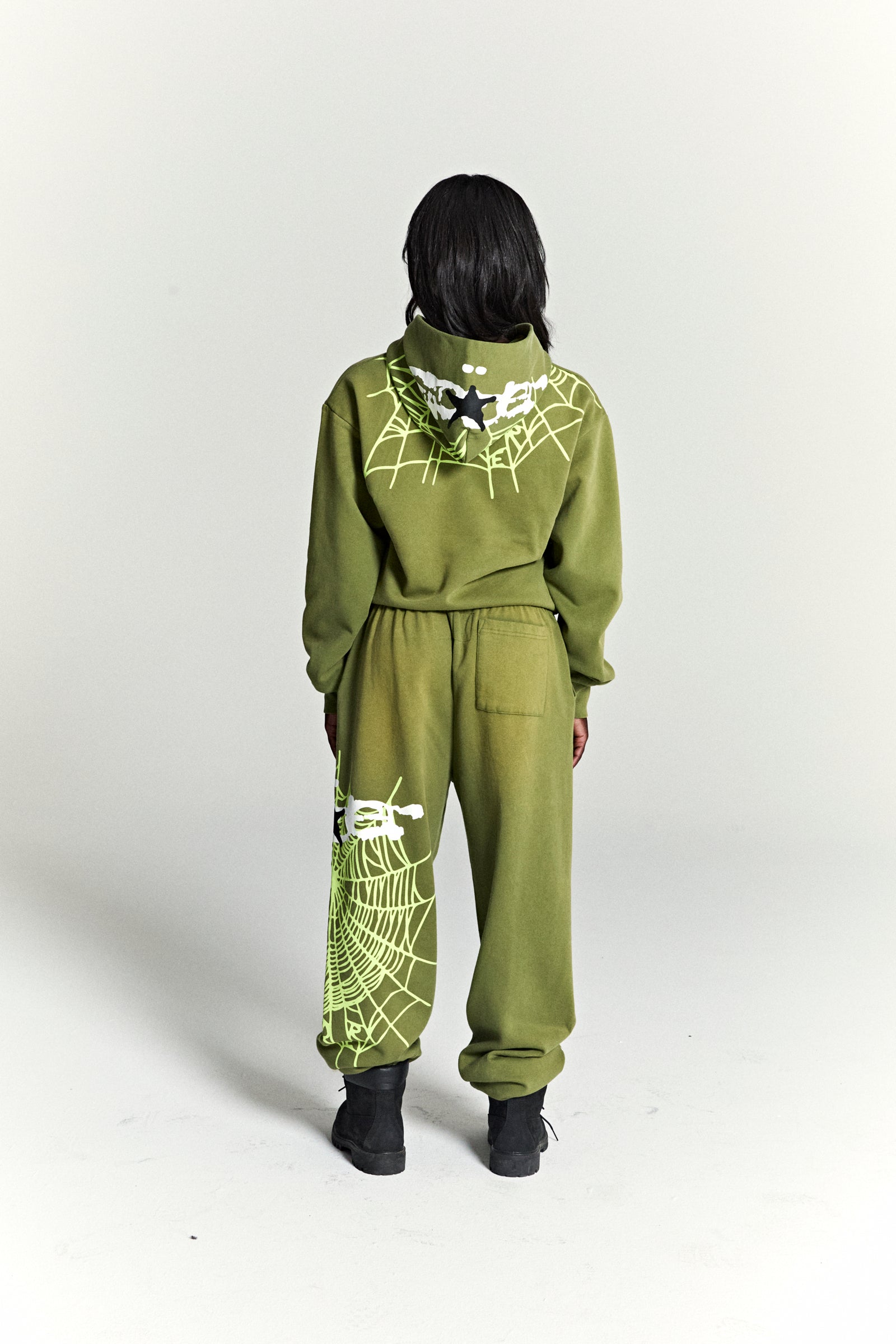Olive green heavy web hoodie and sweatpants with neon green spider web and star puff prints.