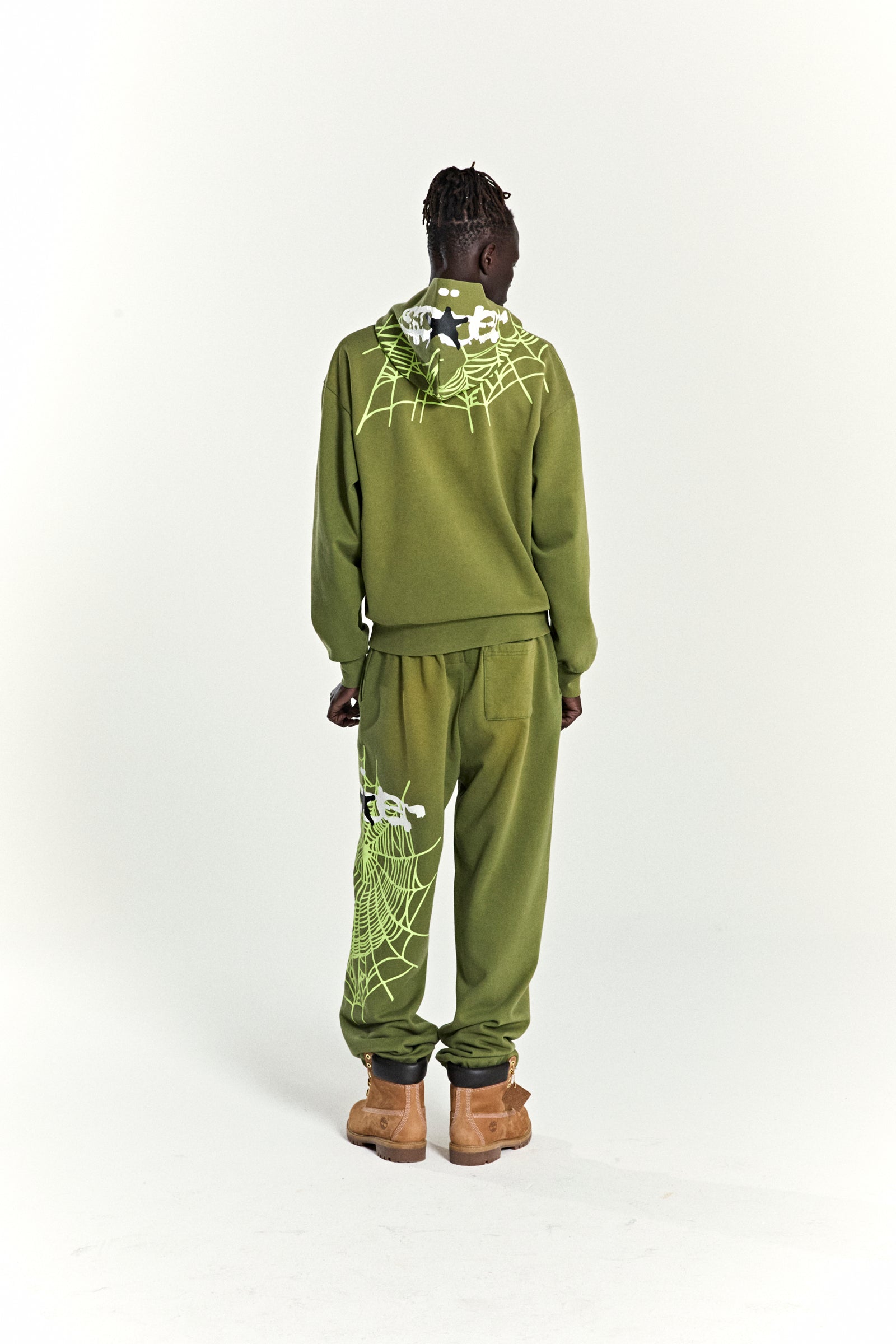Olive green heavy web hoodie and sweatpants with star and web puff prints.