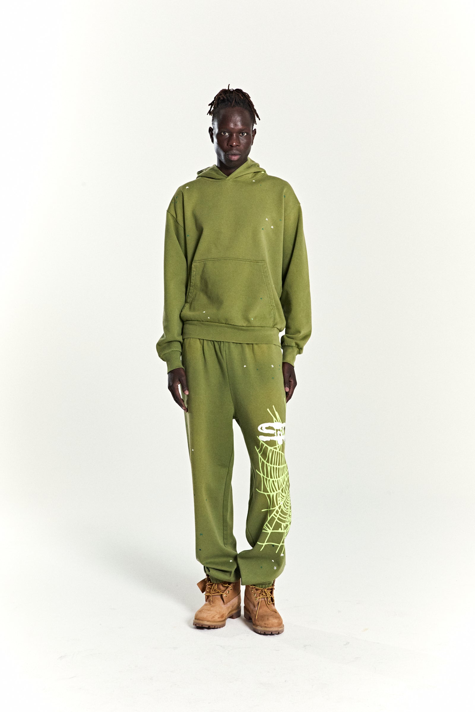 Olive green heavy web hoodie and sweatpants with scattered star and web prints.