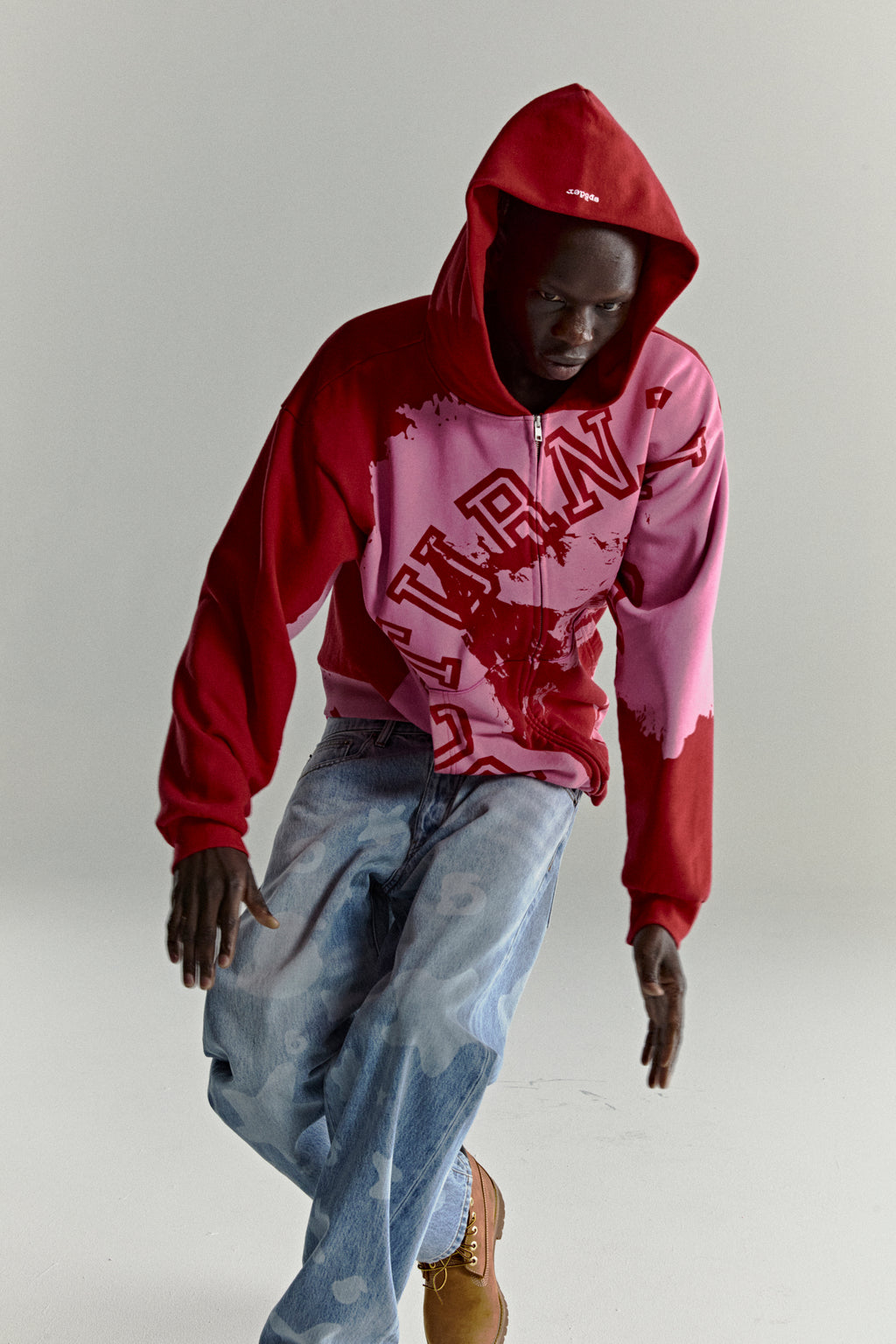 NOCTURNAL ZIP HOODIE: Red and pink color-blocked 13oz cotton fleece hoodie with varsity lettering.