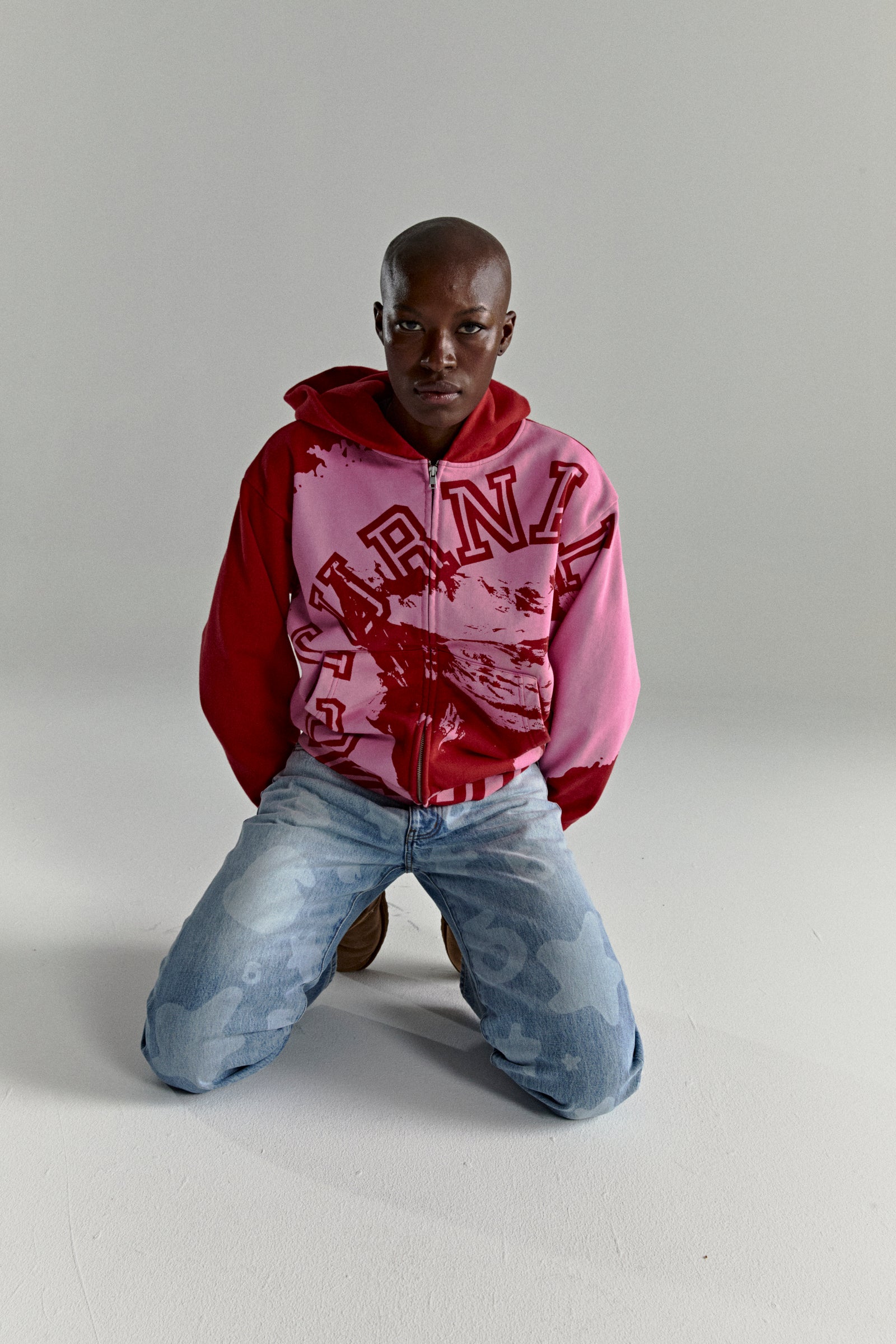 NOCTURNAL ZIP HOODIE: Pink and red color-blocked 13oz cotton fleece hoodie with varsity lettering.