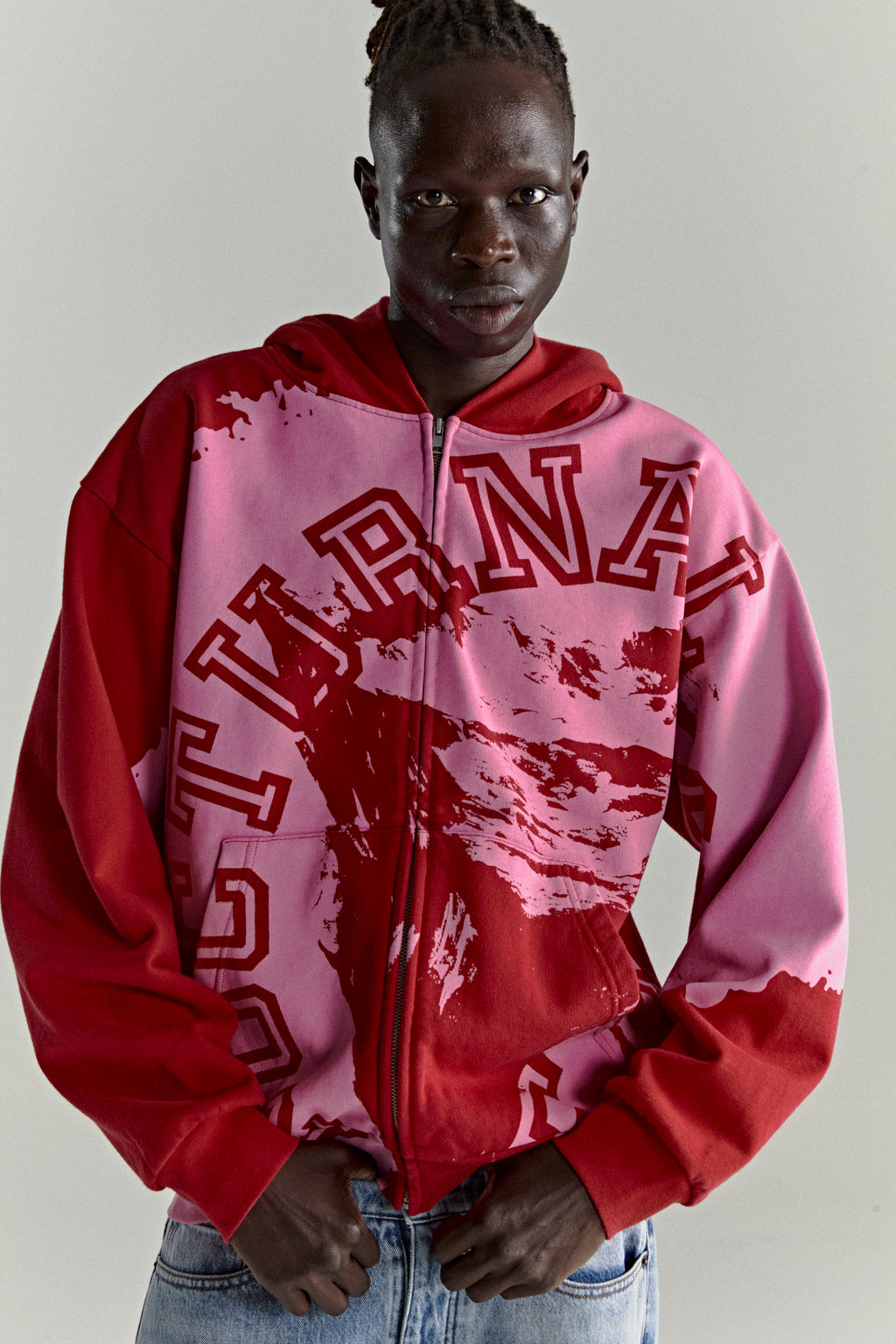 NOCTURNAL ZIP HOODIE: Color-blocked red and pink 13oz cotton fleece hoodie with varsity lettering.