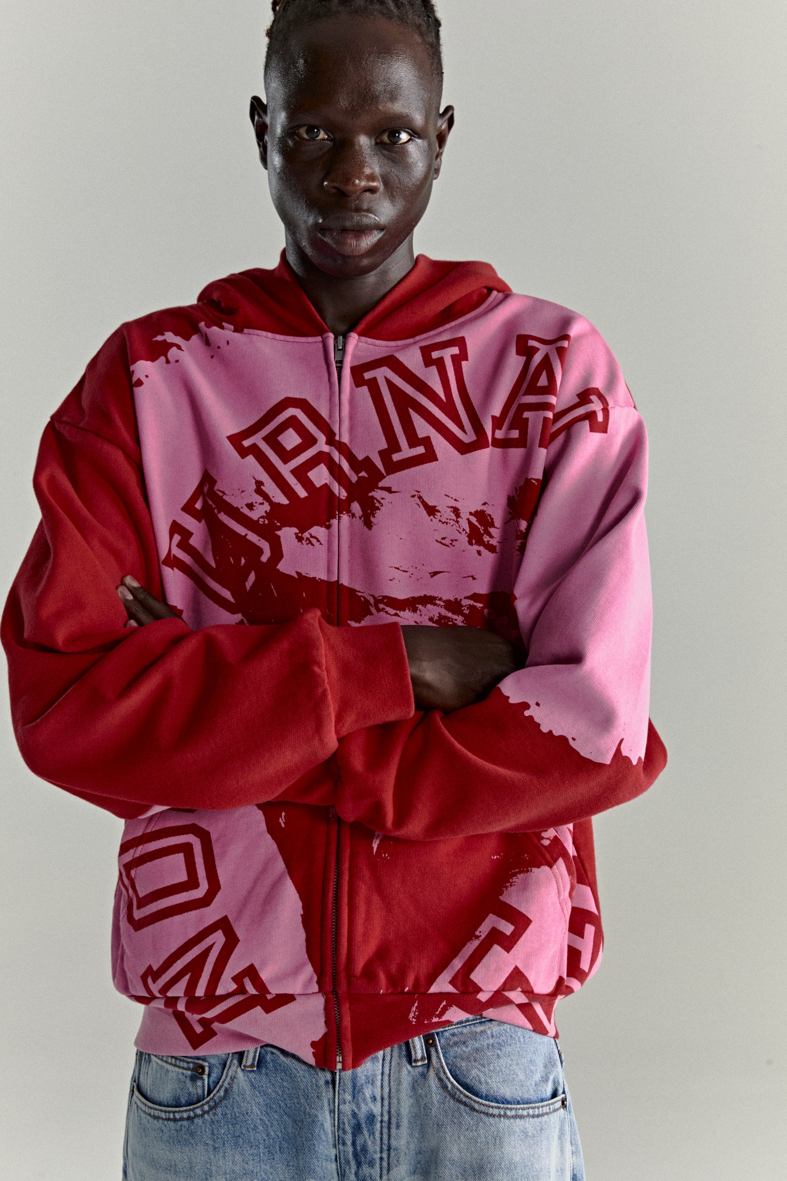 NOCTURNAL ZIP HOODIE: Color-blocked red and pink 13oz cotton fleece hoodie with varsity lettering.