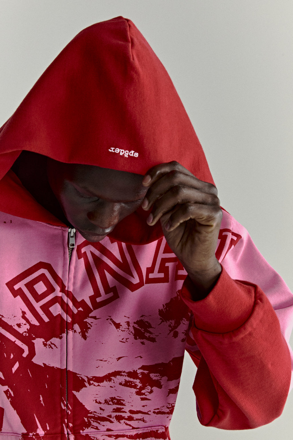 Color-blocked red and pink cotton fleece zip hoodie with varsity lettering and embroidered logo.