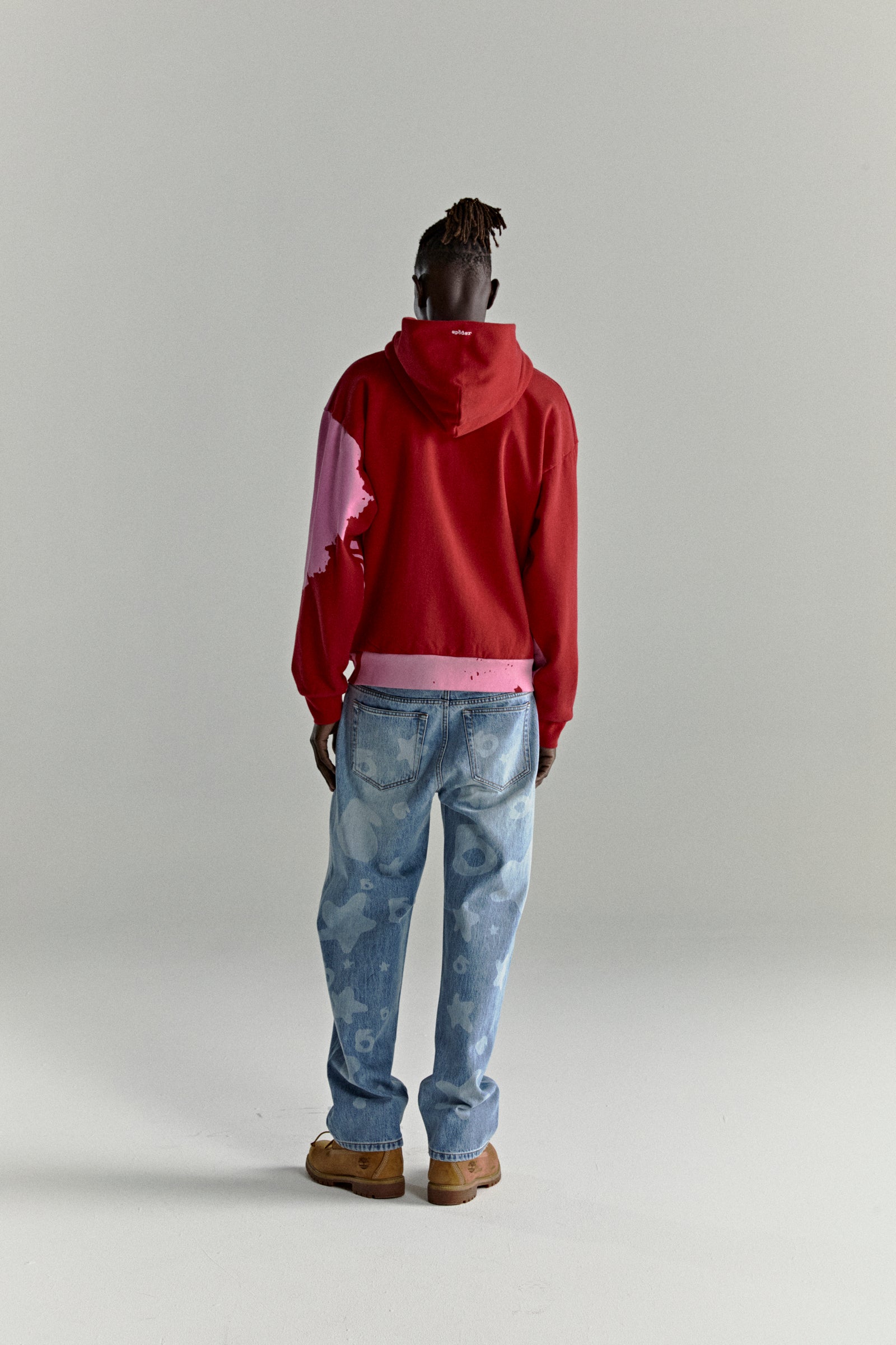 Red NOCTURNAL ZIP HOODIE with pink color-blocked design, embroidered logo, and ribbed cuffs.