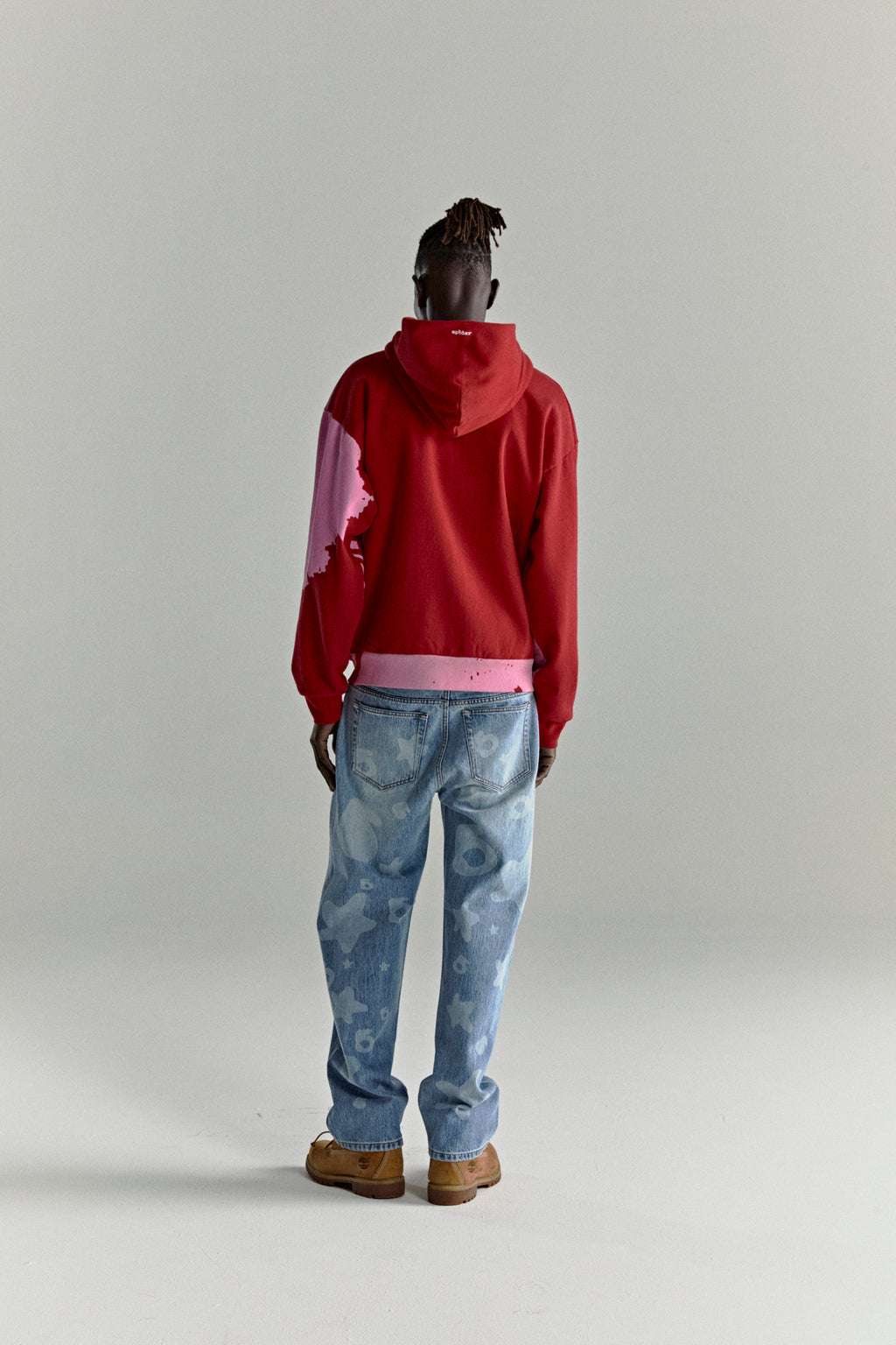 Red NOCTURNAL ZIP HOODIE with pink color-blocked design, embroidered logo, and ribbed cuffs.