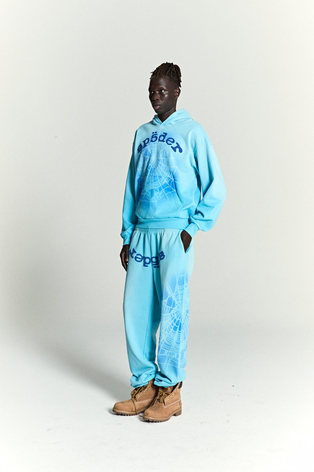 Light blue cotton fleece hoodie and sweatpants with blue spray web V2 print and "Sp5der" logo.