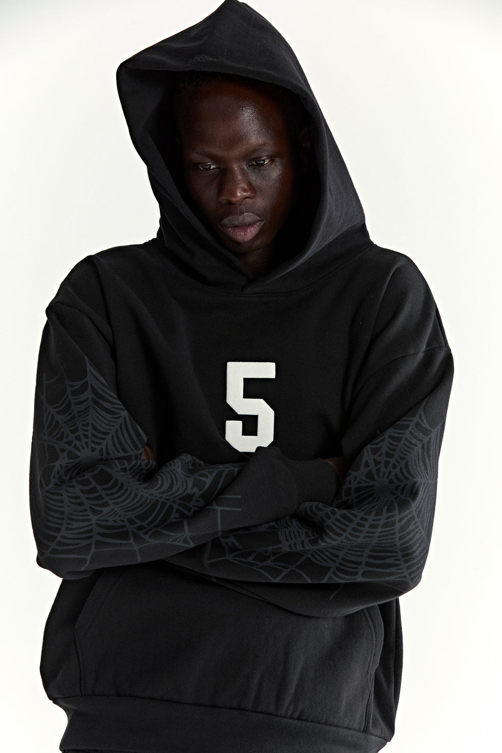 Black 13oz cotton fleece STADIUM HOODIE with white '5' graphic, spider web sleeves, and kangaroo pocket.