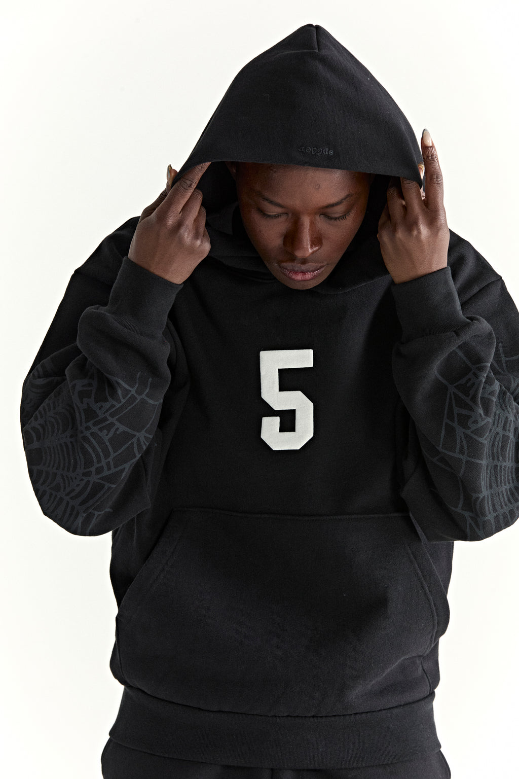 Black 13oz cotton fleece hoodie with white '5' graphic, spider web sleeves, and kangaroo pocket.