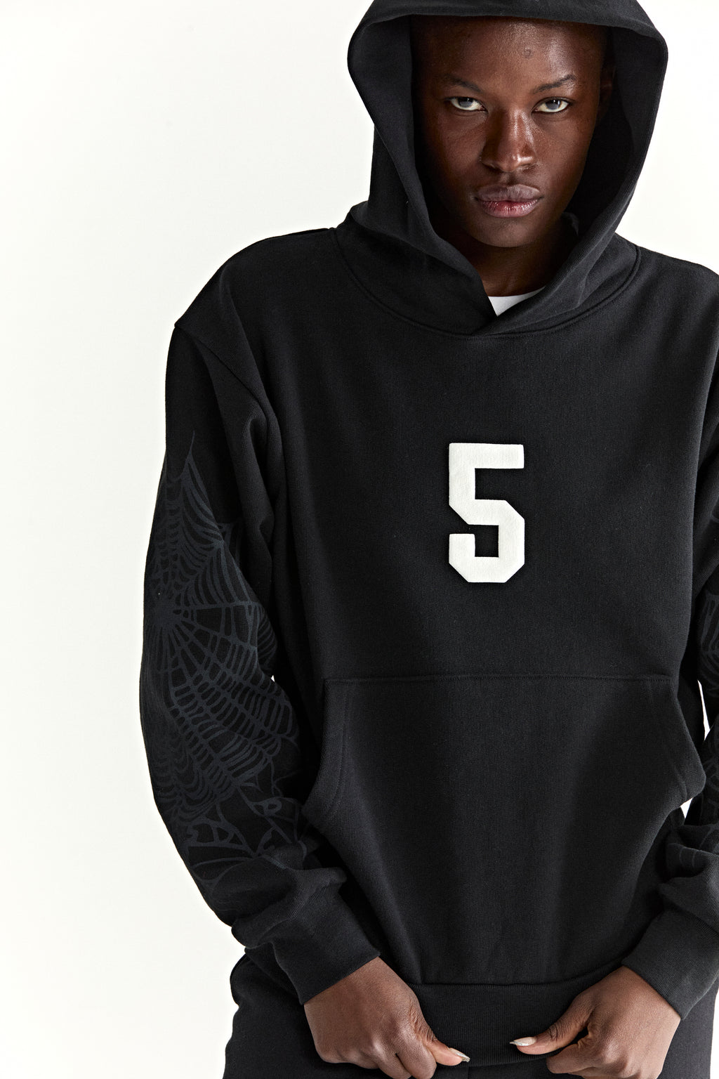 Black 13oz cotton fleece STADIUM HOODIE with white '5' graphic, web detail sleeves, and kangaroo pocket.