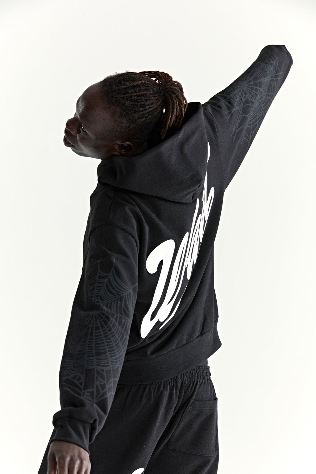 Black 13oz cotton fleece STADIUM HOODIE with 'Wait' script, '5' graphic, and web detail on sleeves.