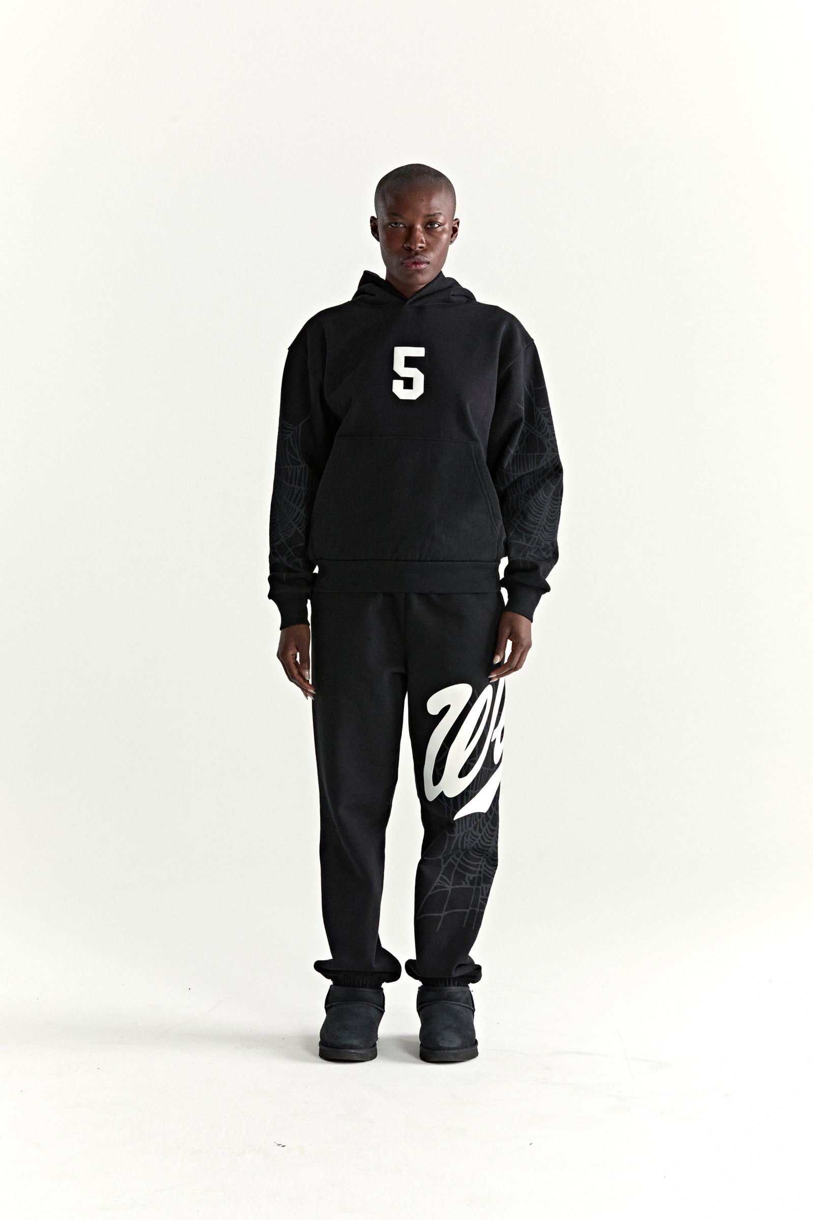 Black cotton fleece hoodie with white '5' graphic and web detail, matching sweatpants with 'Wait' script.