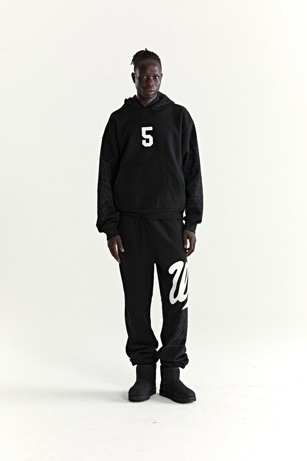 Black 13oz cotton fleece STADIUM HOODIE with white '5' graphic, web detail sleeves, and matching sweatpants.