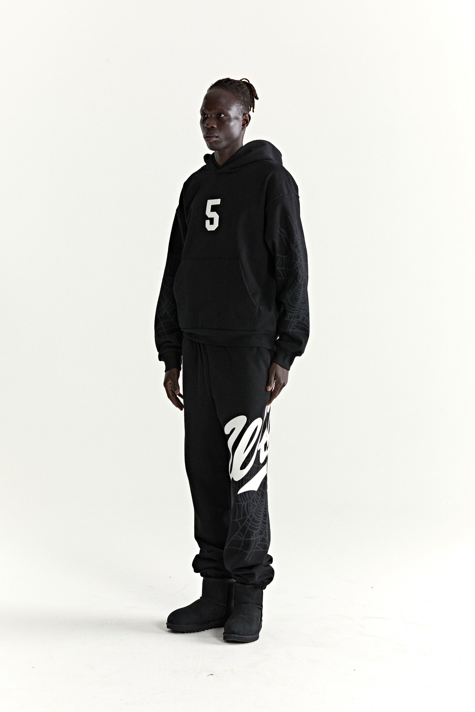 Black 13oz cotton fleece STADIUM HOODIE with white '5' graphic, web sleeves, and matching sweatpants.