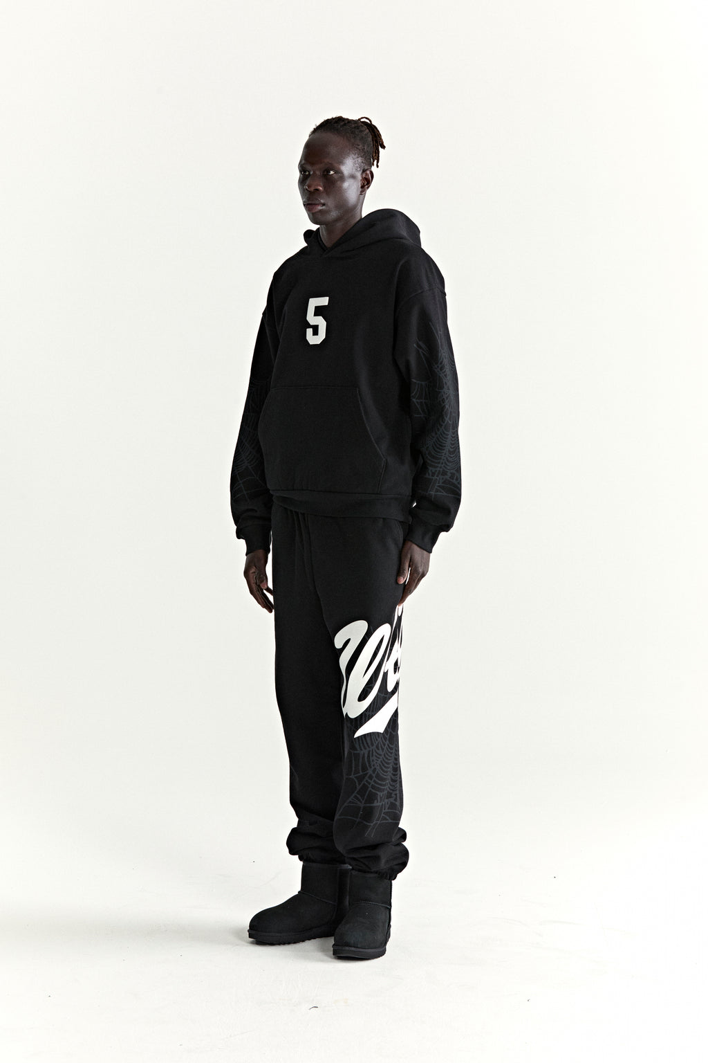 Black 13oz cotton fleece STADIUM HOODIE with white '5' graphic, web sleeves, and matching sweatpants.
