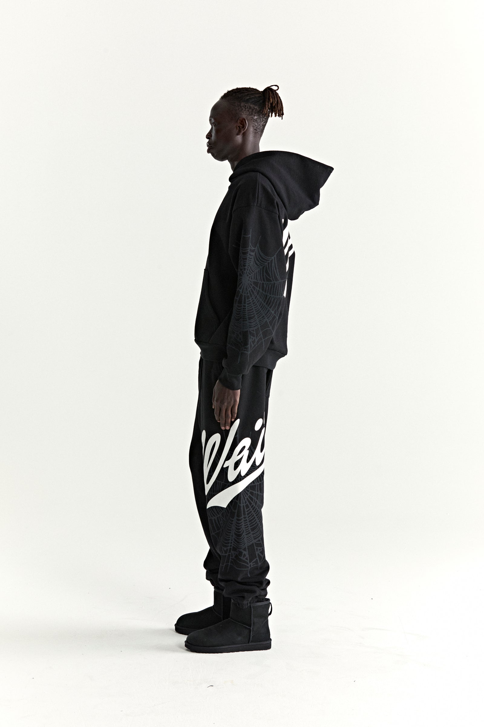 Black cotton fleece hoodie and sweatpants with white 'Wait' script, '5' graphic, and spiderweb details.