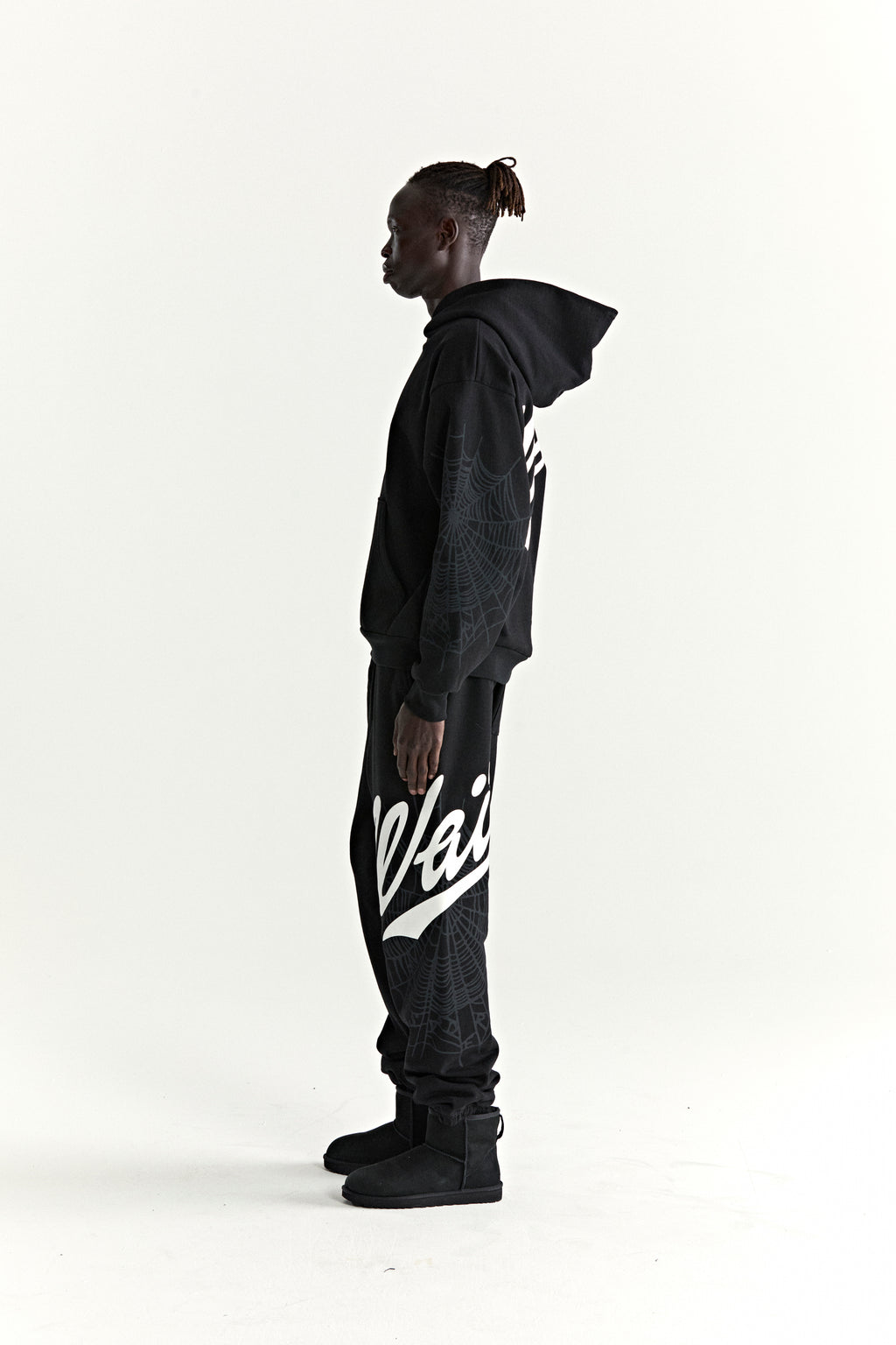 Black cotton fleece hoodie and sweatpants with white 'Wait' script, '5' graphic, and spiderweb details.