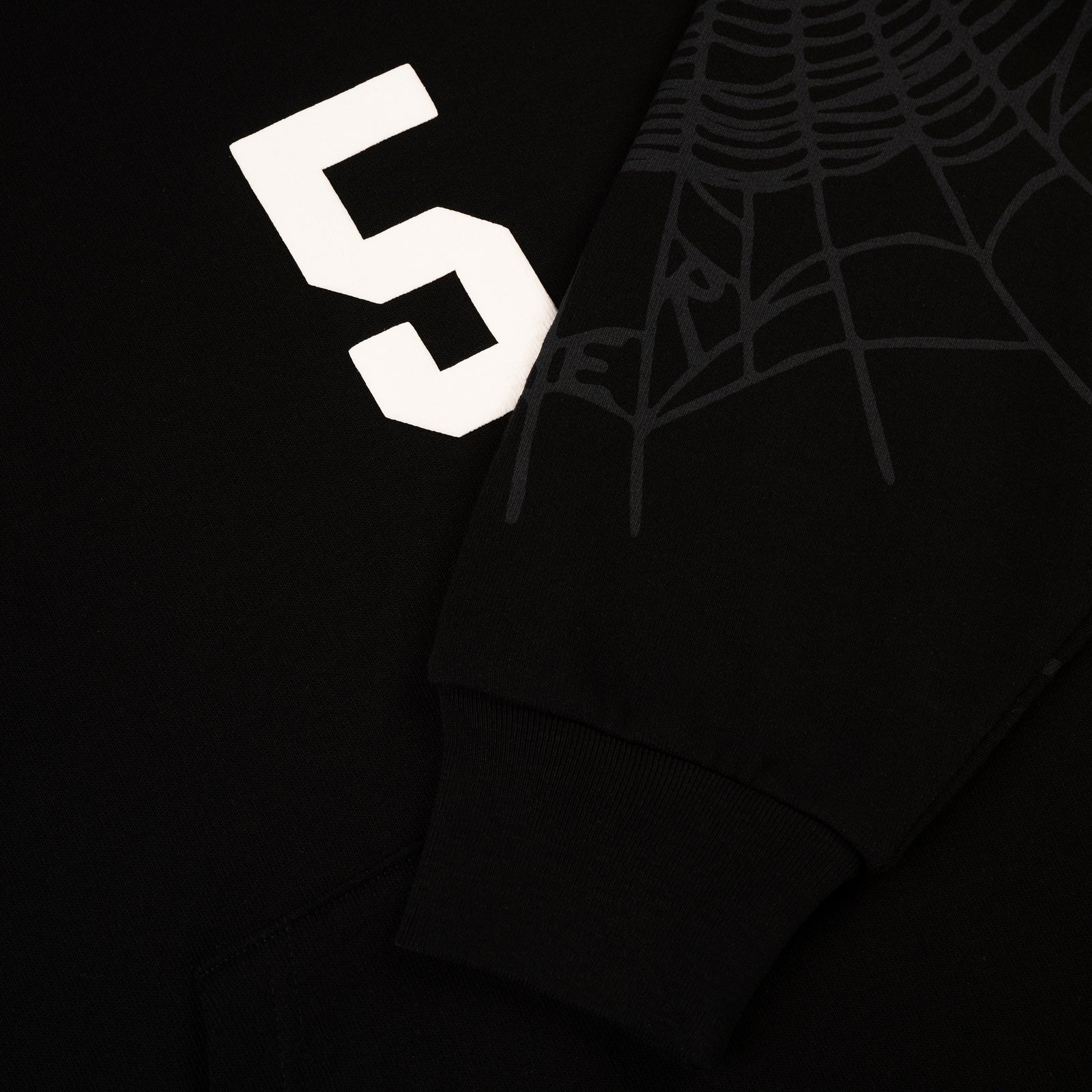 Black 13oz cotton fleece hoodie with white '5' graphic, spider web sleeve detail, and ribbed cuff.