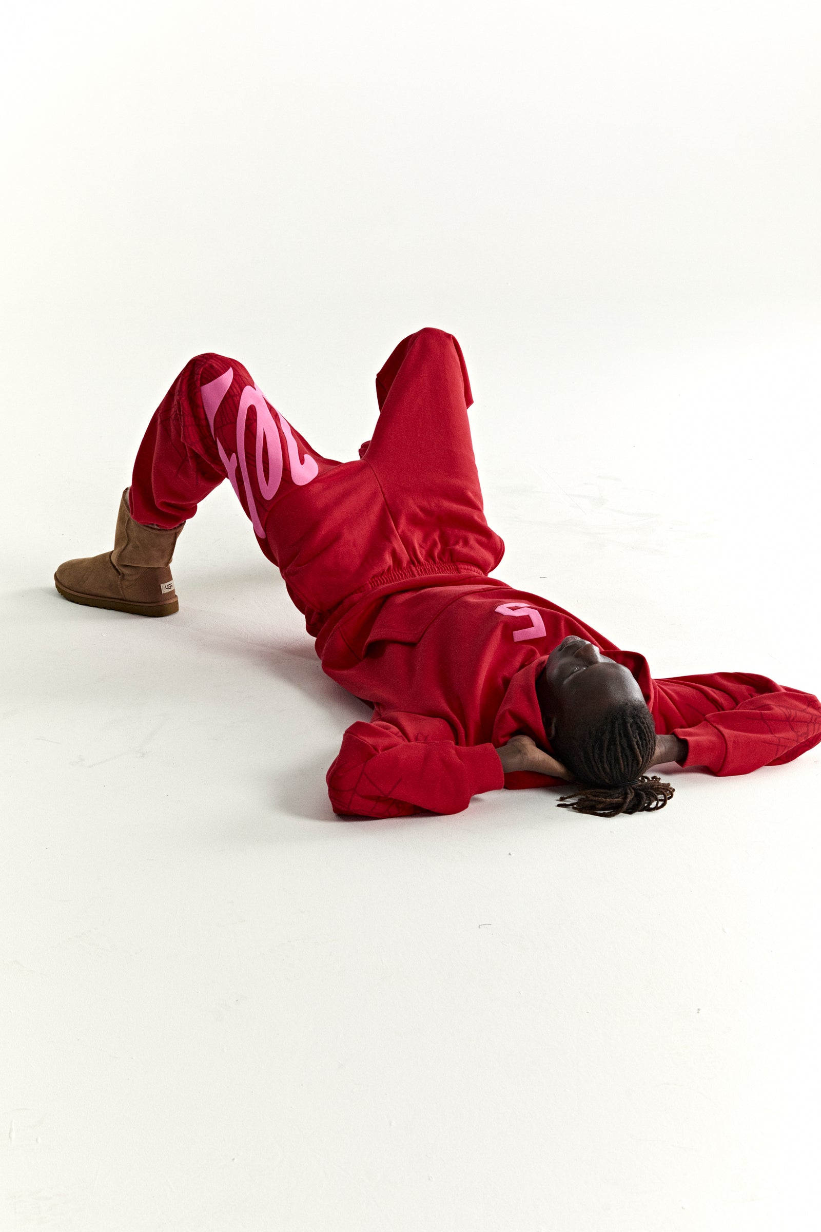 Red 13oz cotton fleece STADIUM HOODIE and sweatpants with pink puff print, web detail, and kangaroo pocket.