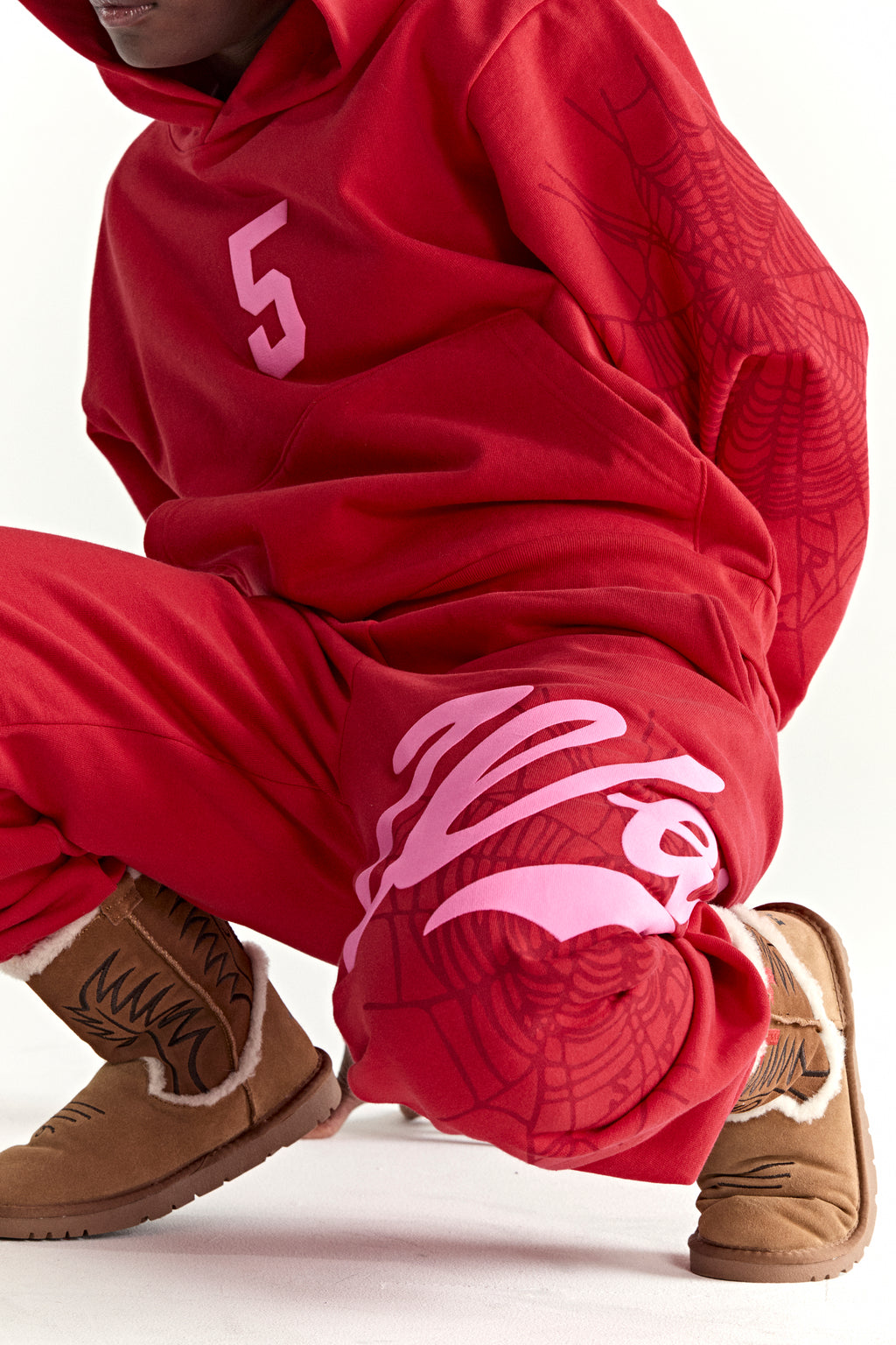 Red 13oz cotton fleece hoodie and sweatpants with pink '5' graphic, spiderweb sleeve/leg details.