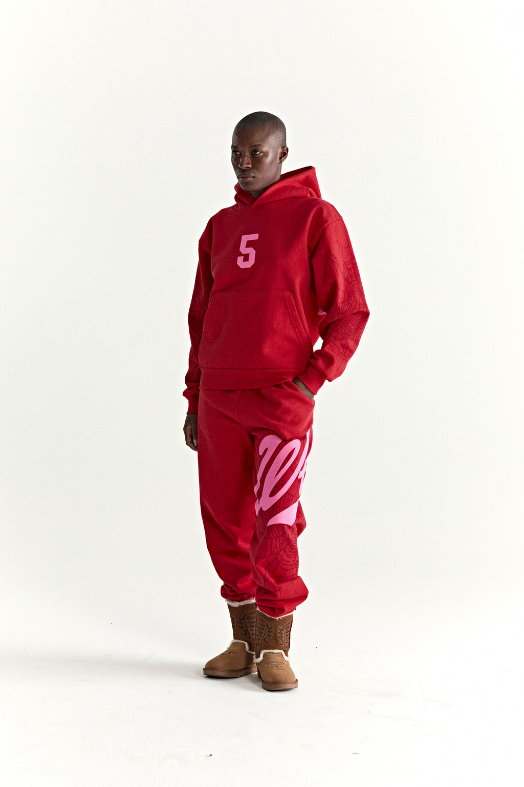 Red 13oz cotton fleece hoodie and sweatpants set with pink '5' graphic, web detail, and kangaroo pocket.