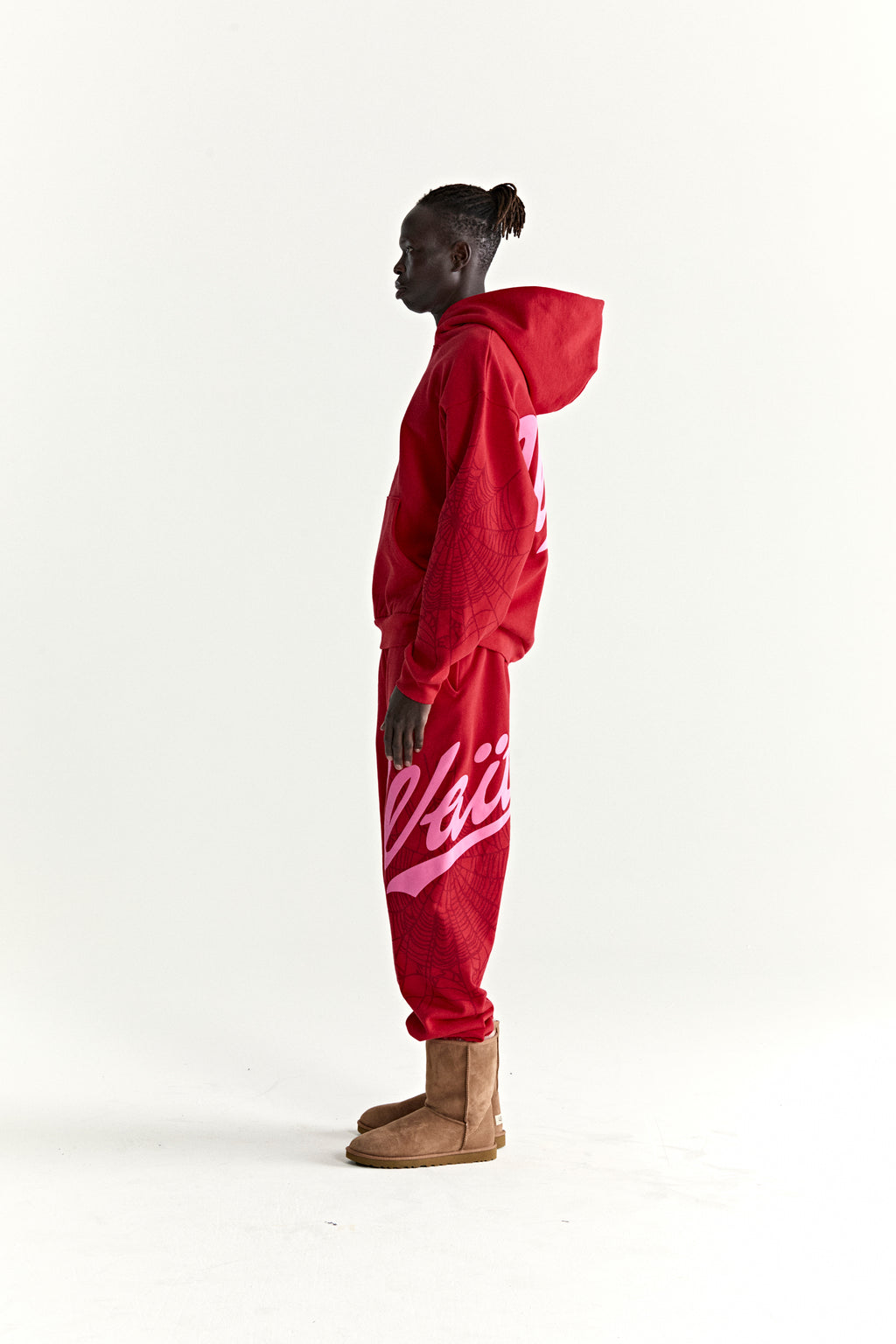 Red 13oz cotton fleece hoodie and sweatpants with pink puff print, web detail, and text.