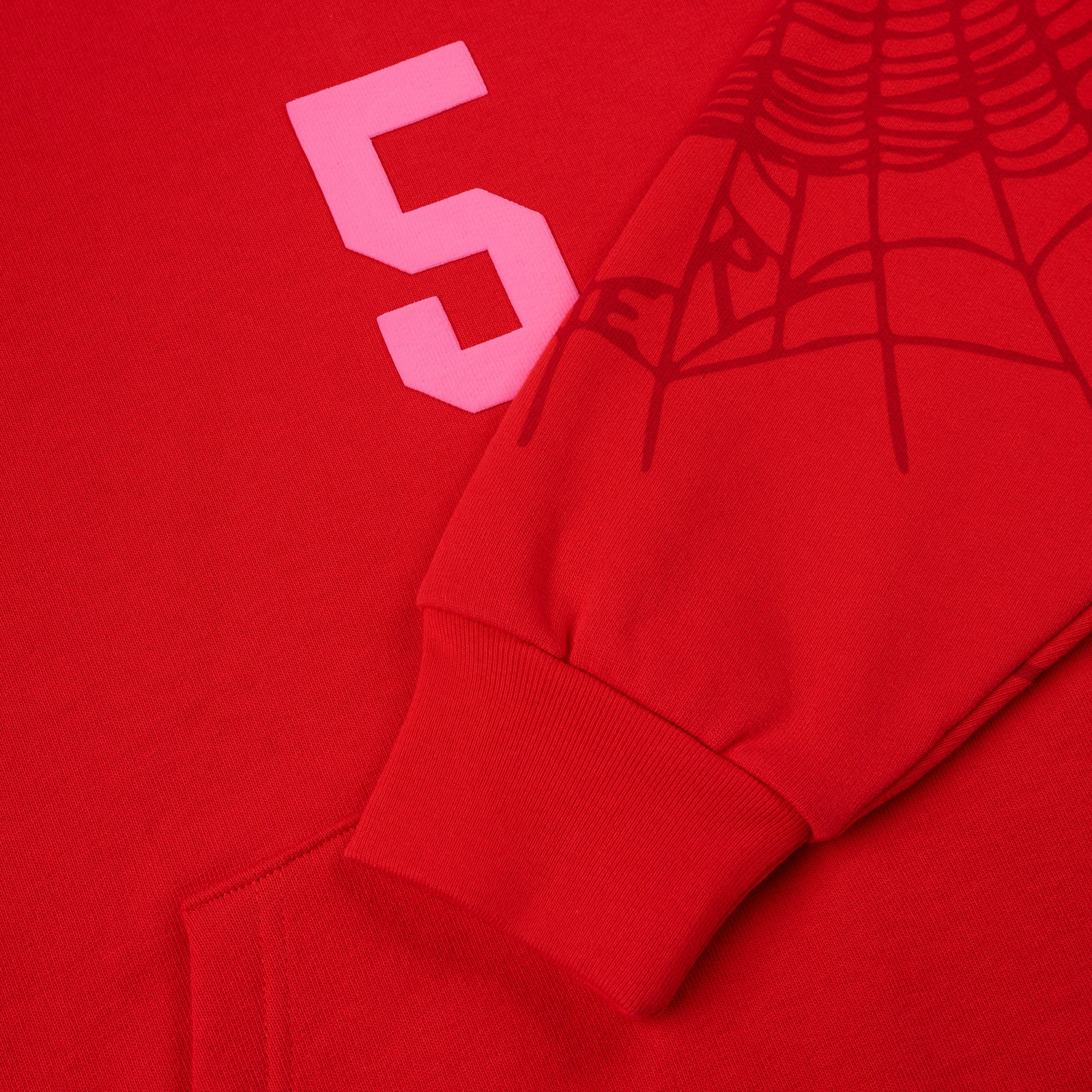 Red 13oz cotton fleece hoodie with pink '5' graphic, web detail on sleeve, and ribbed cuff.