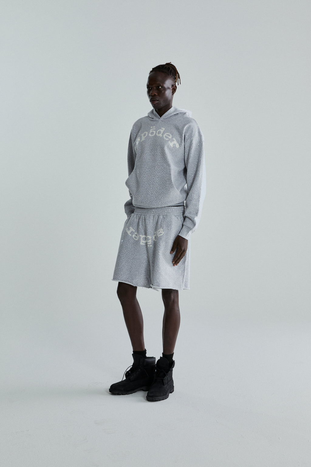 Gray VVS Hoodie and shorts set with tonal rhinestones and "SP5DER" text, worn by a model.