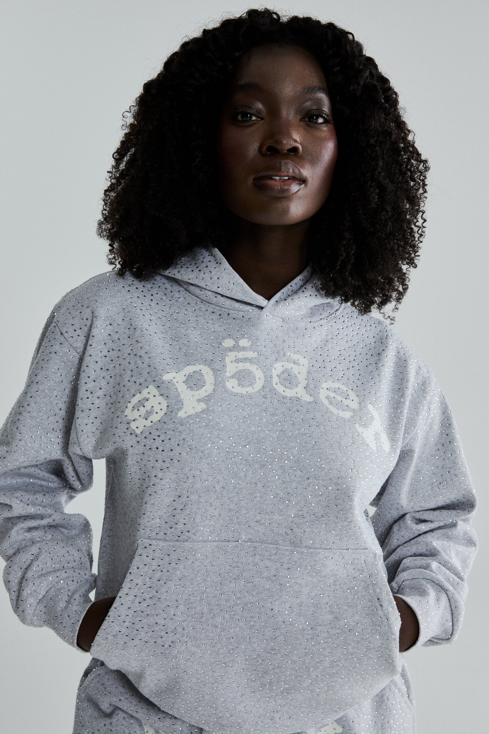 Gray VVS Hoodie with all-over tonal rhinestones, SP5DER text, and kangaroo pocket.