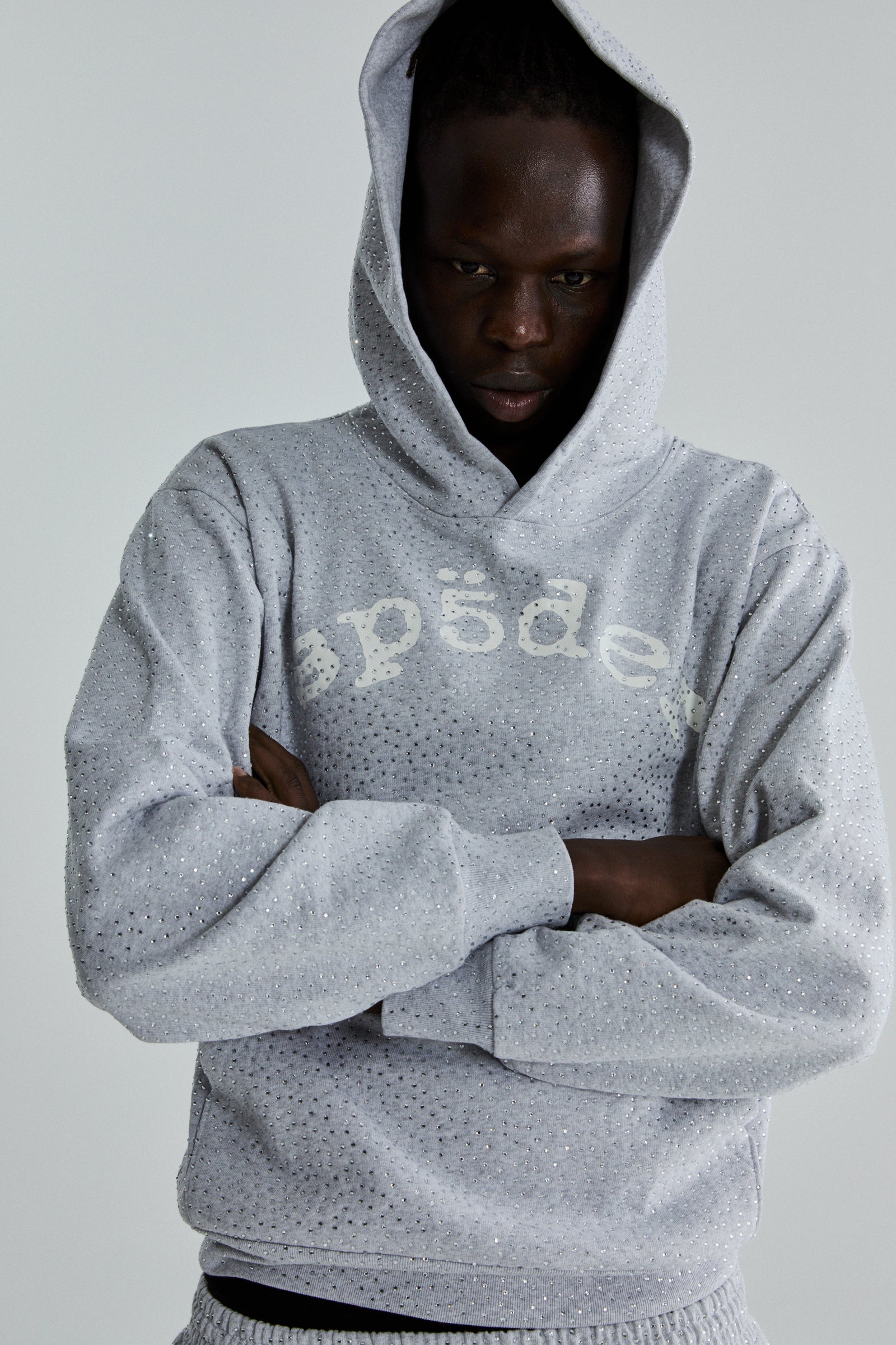 Gray 13oz cotton fleece VVS Hoodie with all-over tonal rhinestones and "SP5DER" chest print.
