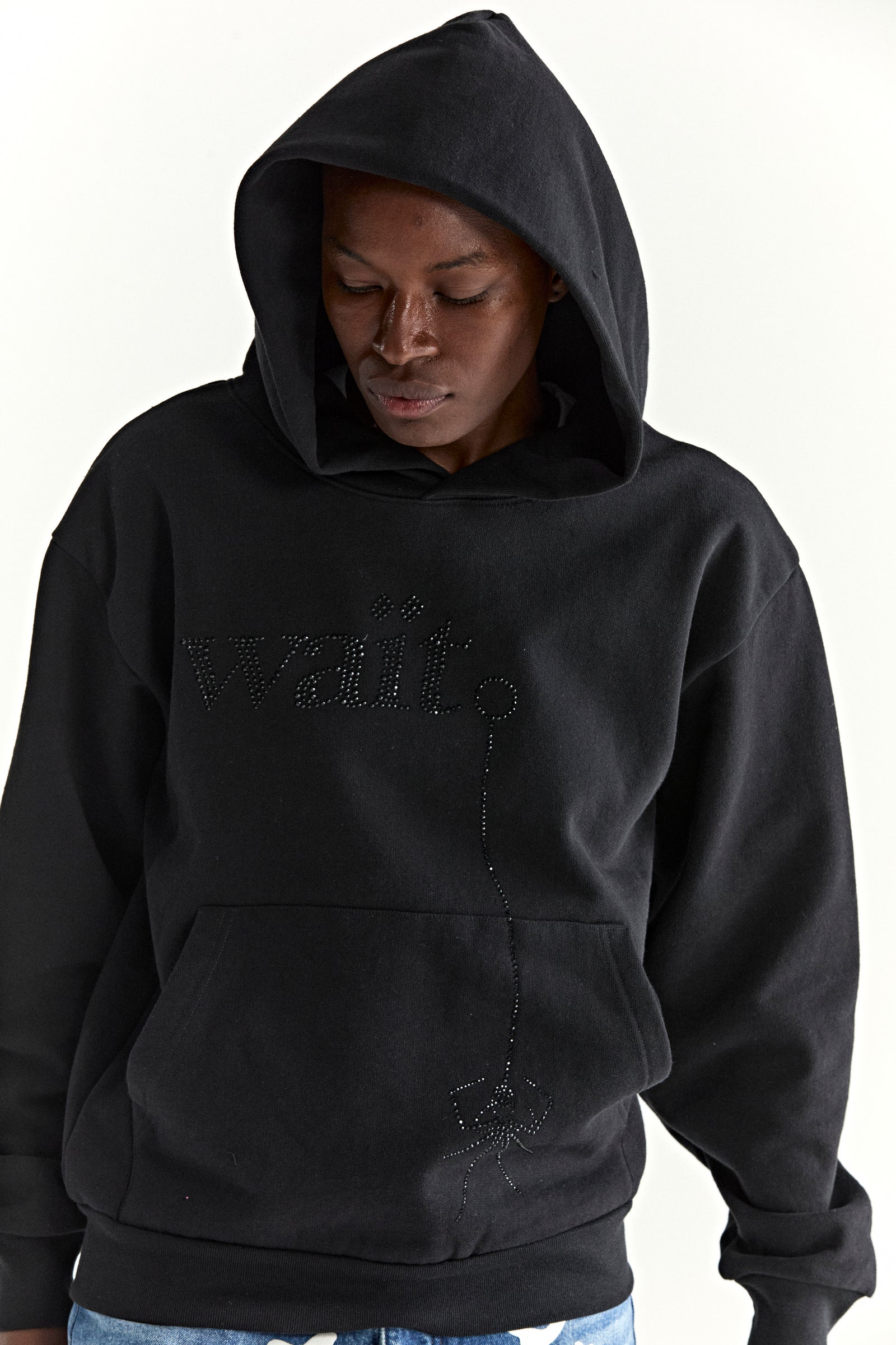 Black 13oz cotton fleece hoodie with rhinestone "Wait" detail, kangaroo pocket, and rib knit cuffs.