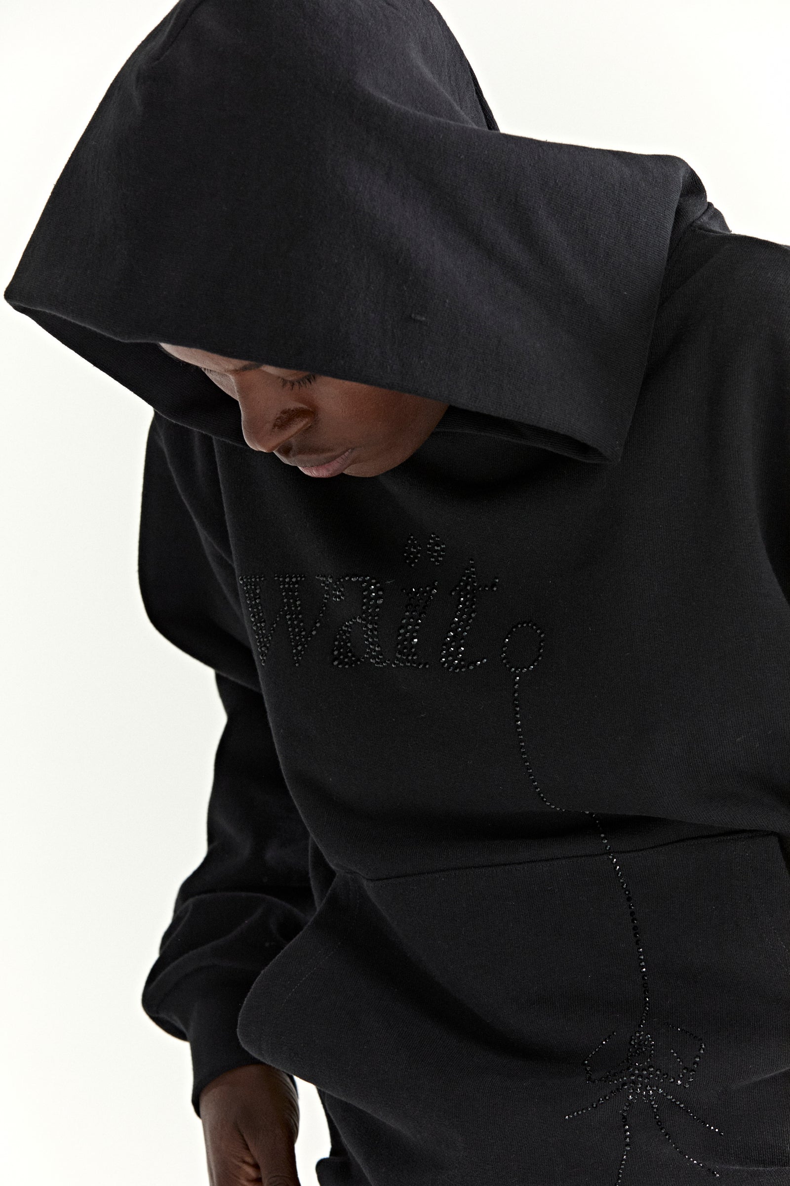 Black 13oz cotton fleece WAIT STONE HOODIE with rhinestone "Wait" detail and spider graphic.