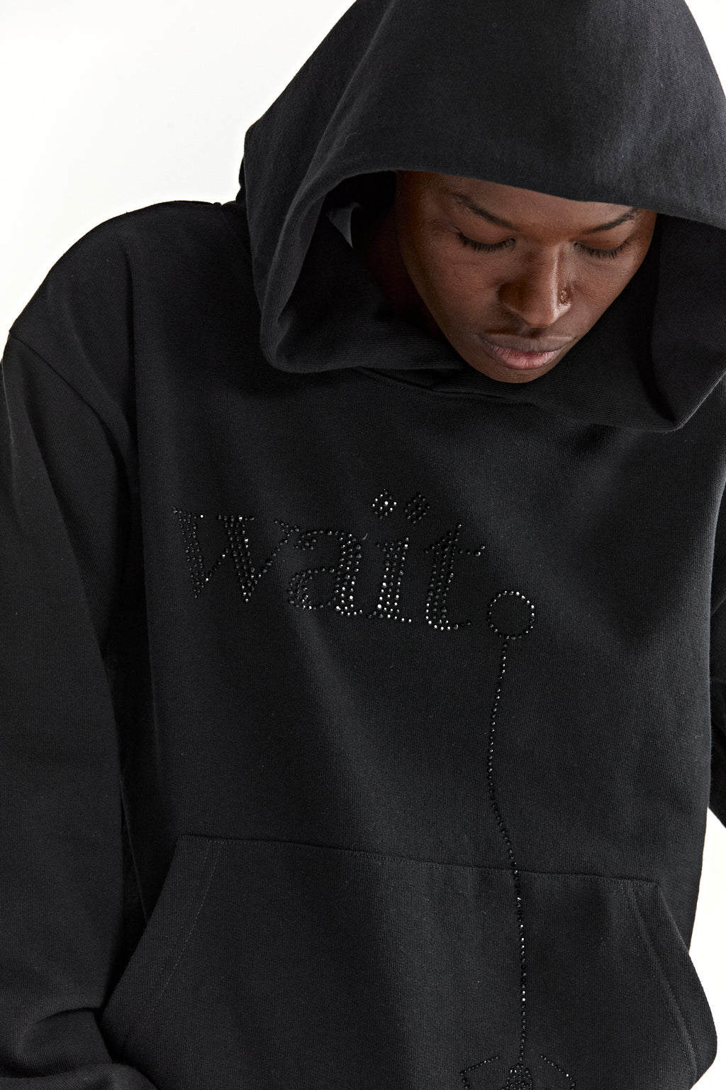 Black cotton fleece hoodie with rhinestone "Wait" detail and kangaroo pocket.