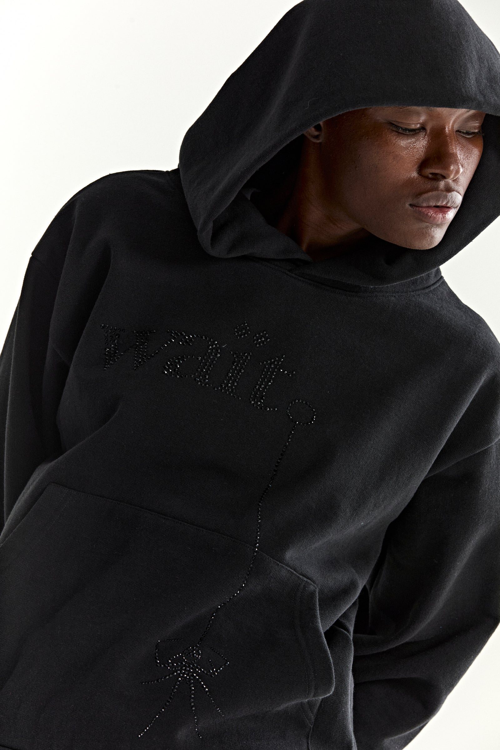 Black cotton fleece hoodie with rhinestone 'Wait' detail and spider graphic, kangaroo pocket.